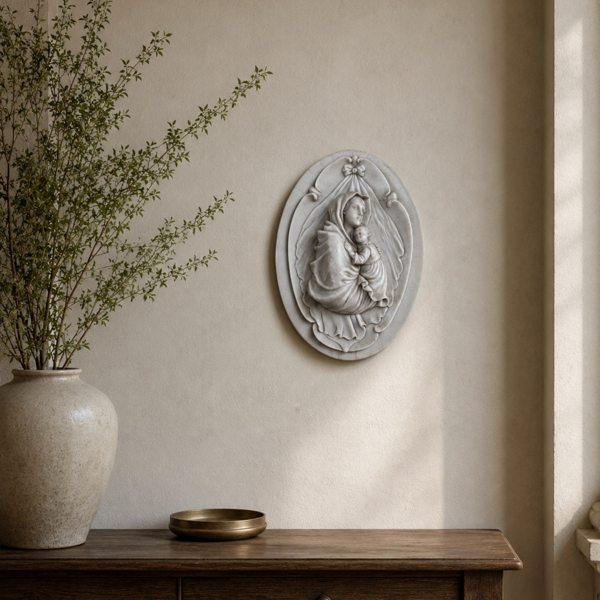 Veiled Madonna oval marble plaque shown in a hallway niche