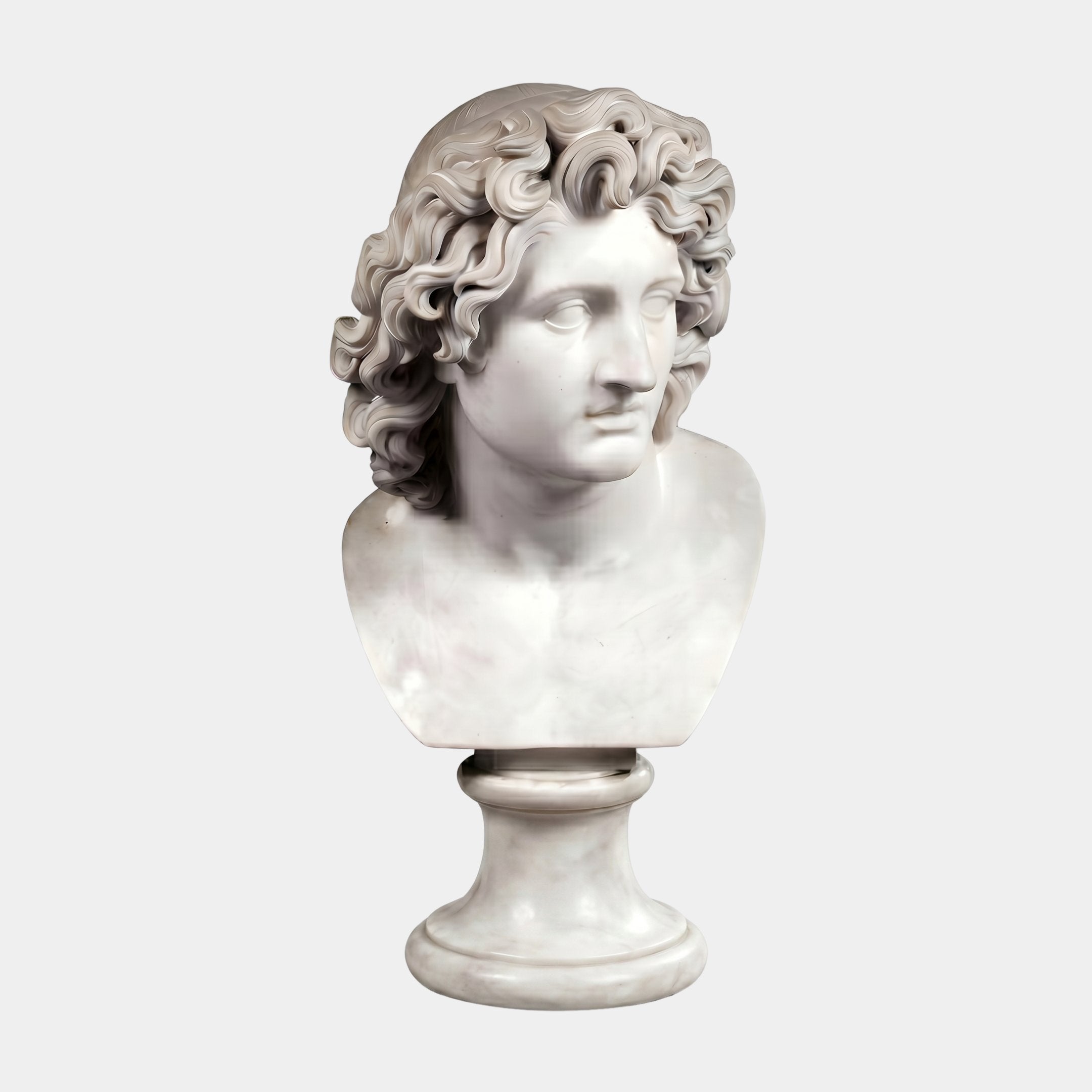 Apollo Marble Bust Sculpture (50cm) by Giant Sculptures: features a wavy-haired man with classical beauty, set on a round pedestal against a plain light background.