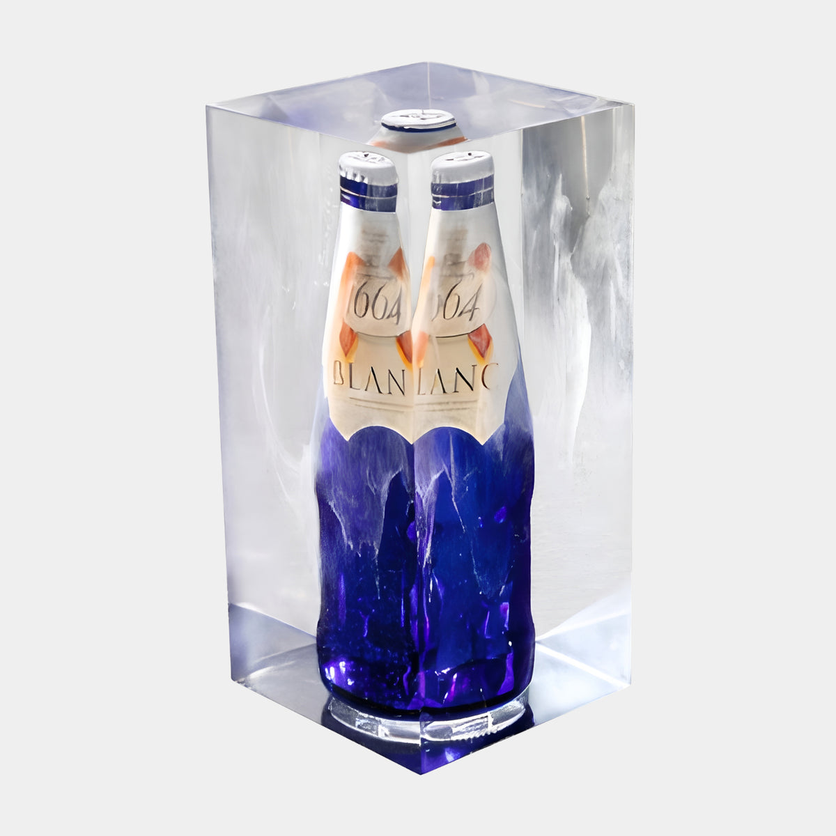 Clear & Blue Twin Bottle Block Resin Sculpture - 24cm, two cobalt blue bottles with white labels encased in clear resin with milky veils, on a plain white background.