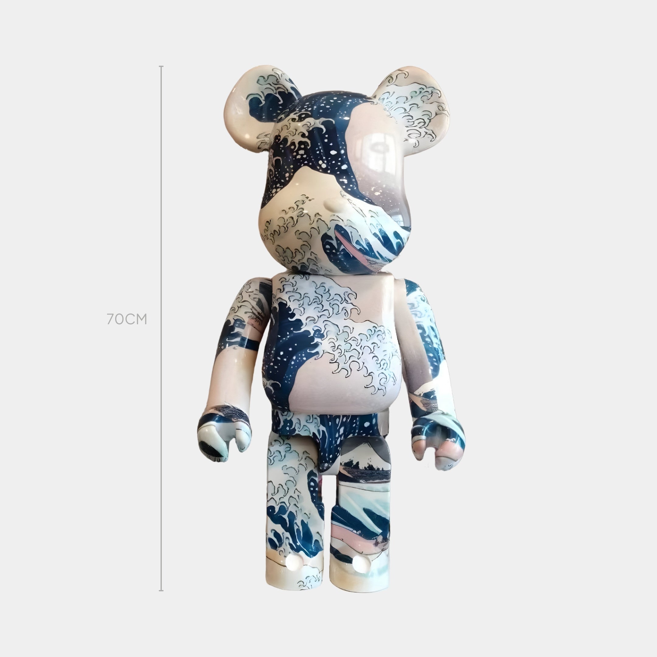 The Ocean Surge Bear Sculpture - 70cm by Giant Sculptures features blue and white patterns inspired by Hokusai’s Wave, making it a striking designer piece that pays tribute to Japanese art.