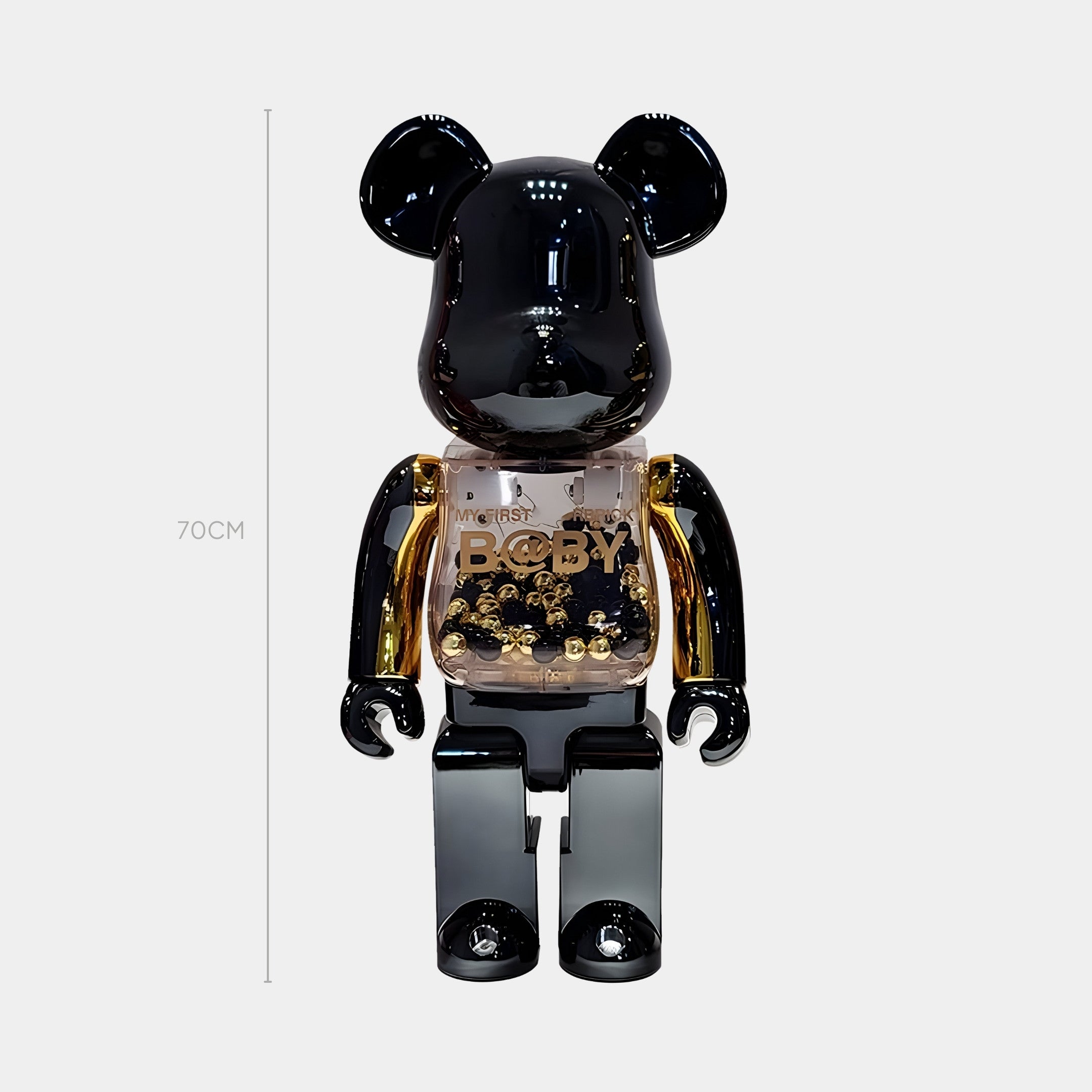 The Onyx Gilded Beads Bear Sculpture by Giant Sculptures stands 70cm tall with a glossy black head, arms, and legs. Its transparent torso features gold-plated beads and the word BODY in bold letters, upright against a white background.