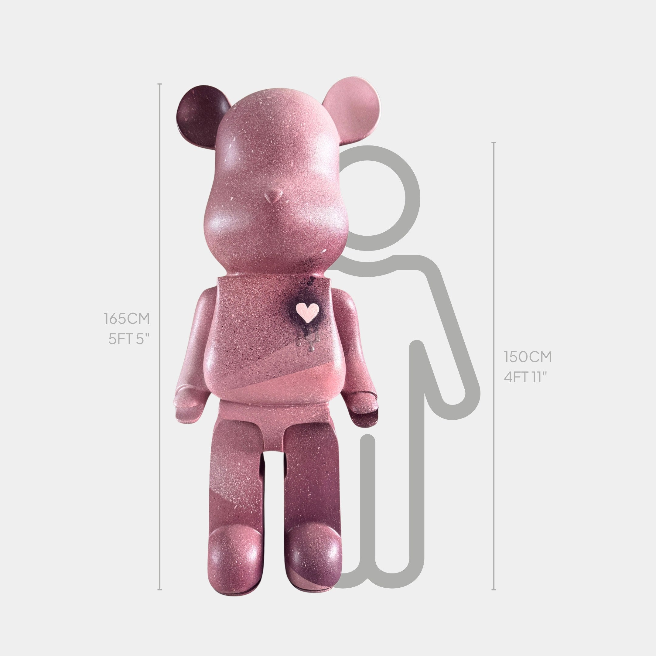 The Pinque Bear Sculpture - 165cm by Giant Sculptures, a large pink bear with a heart on its chest, stands in front of a gray 150 cm outline for scale, emphasizing its impressive 165 cm (5 ft 5 in) height.