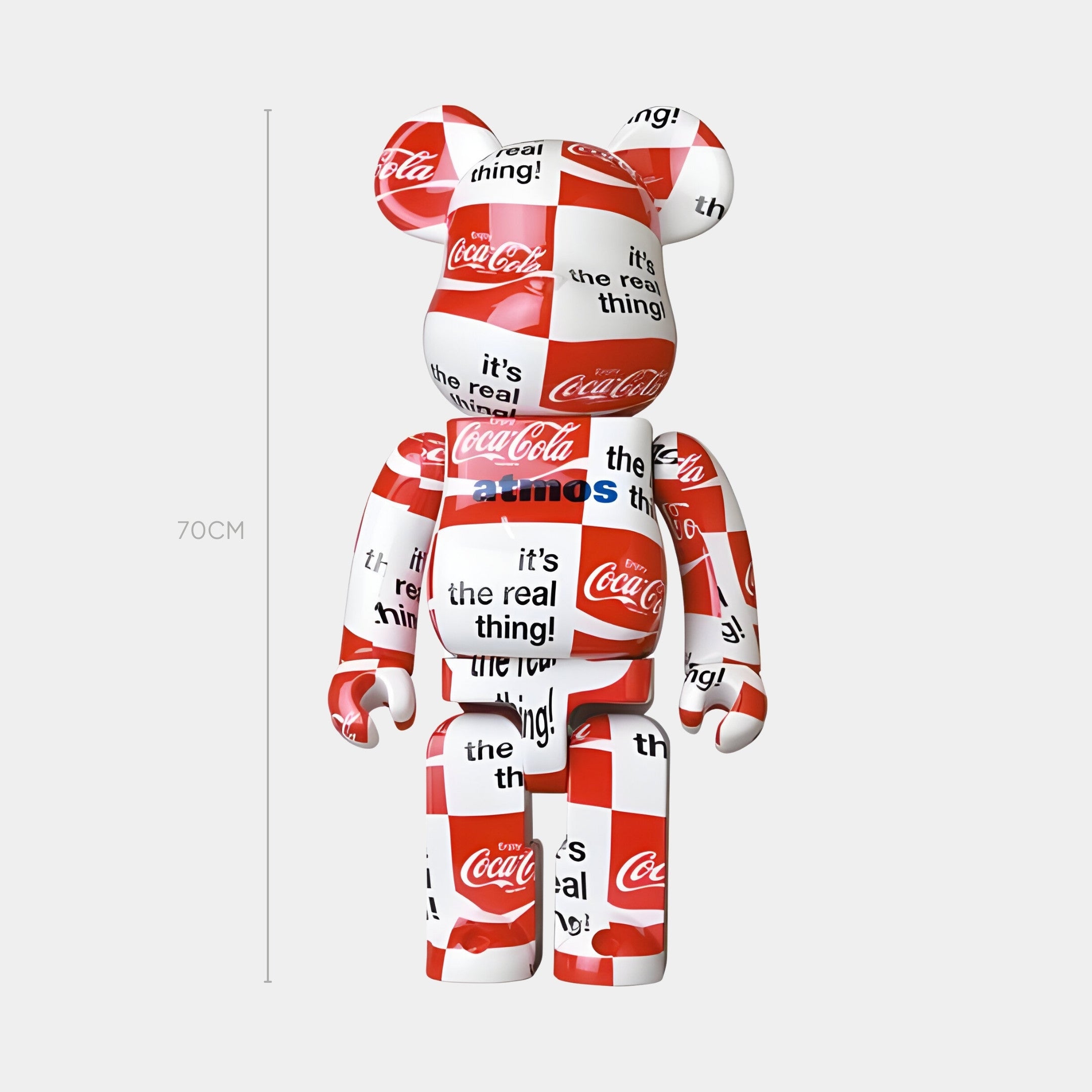 The Pop Checkerboard Bear Sculpture - 70cm by Giant Sculptures is a bear-shaped Pop-Art figurine in red, white, and black with Coca-Cola logos, its the real thing! and atmos text on a plain white background.