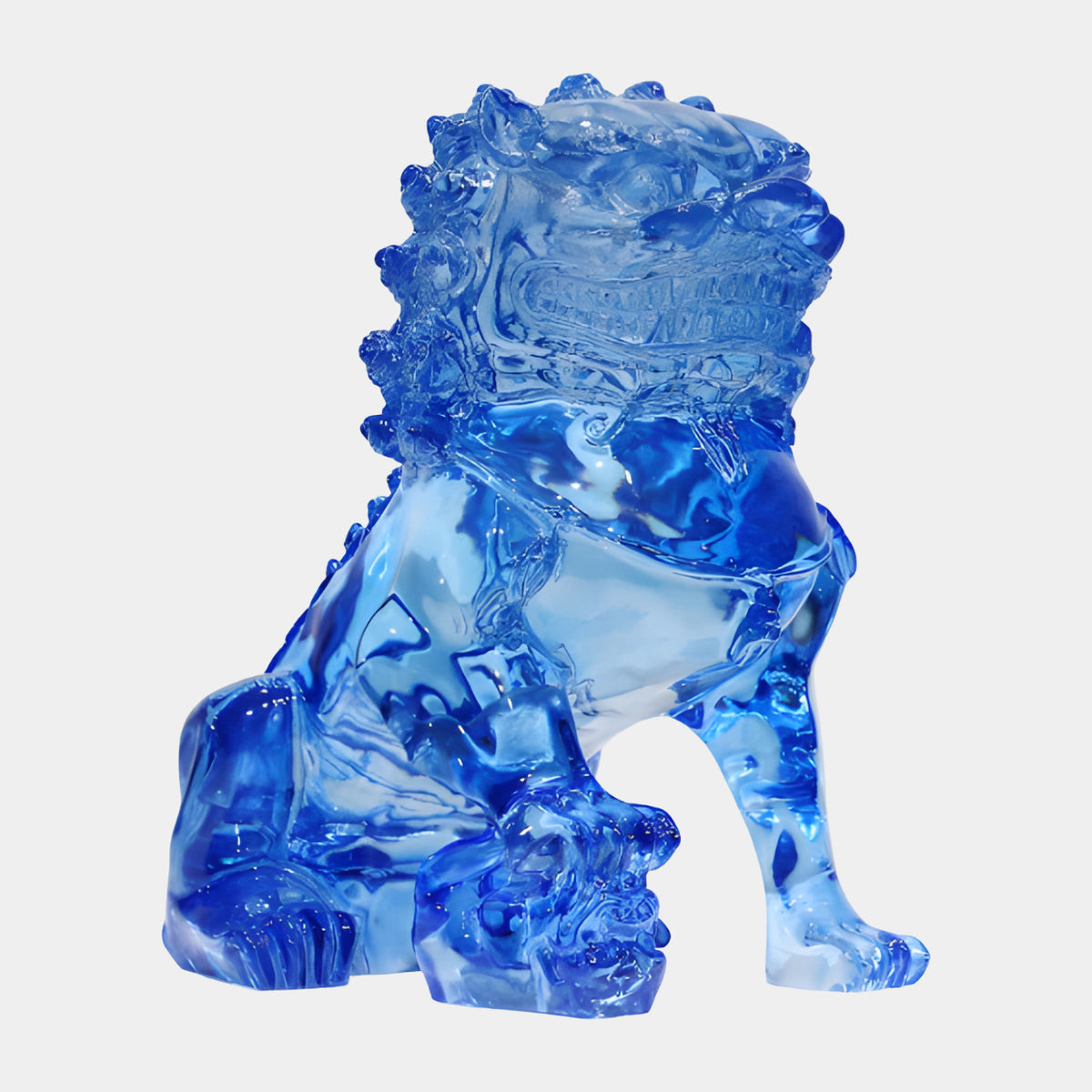 Blue Guardian Lion with Ball Under One Paw Cast Resin Sculpture, 38cm, translucent cobalt blue finish, curled mane and collar detail, on a plain white background.