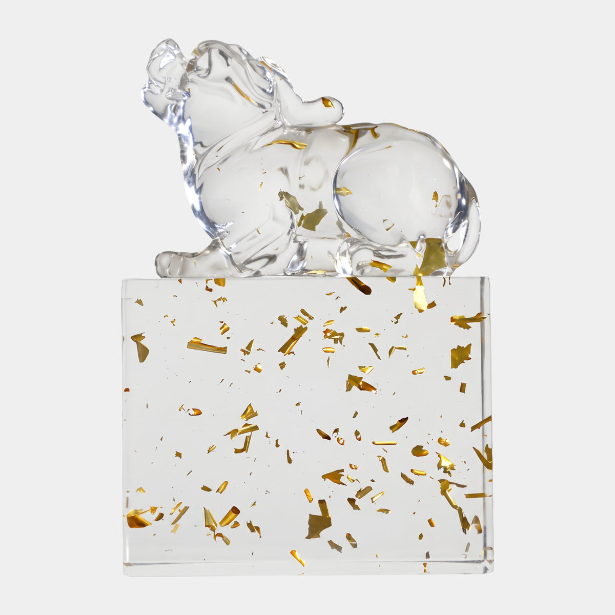Clear Recumbent Dog on Gold-Flecked Resin Block, 30cm, clear polished dog lying with head raised atop a gold leaf-flecked resin base, plain white background.
