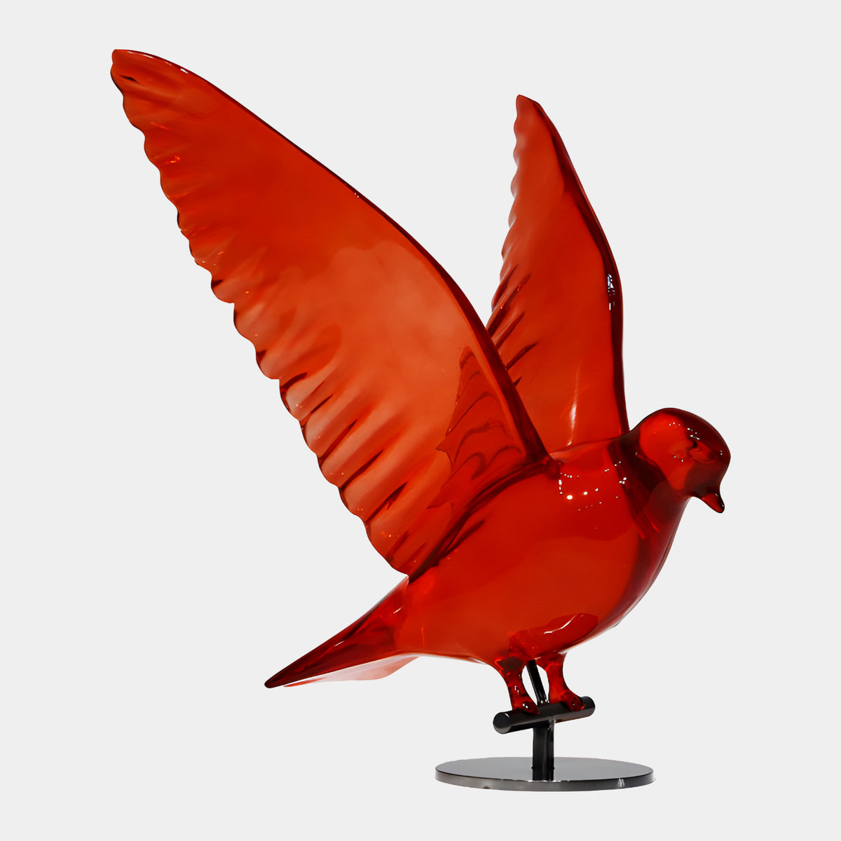 Red Dove with Raised Wings Cast Resin Sculpture, 38cm, translucent red finish with ribbed wings raised and swept back, on a black stand, plain white background.