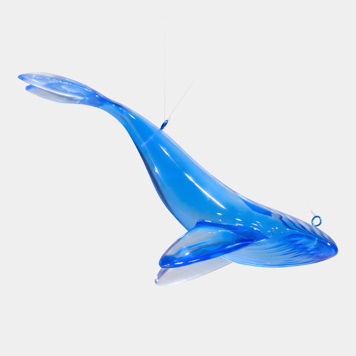 Blue Hanging Whale Cast Resin Sculpture, 28cm, translucent blue humpback whale with swept-back flippers suspended on two lines against a plain white background.