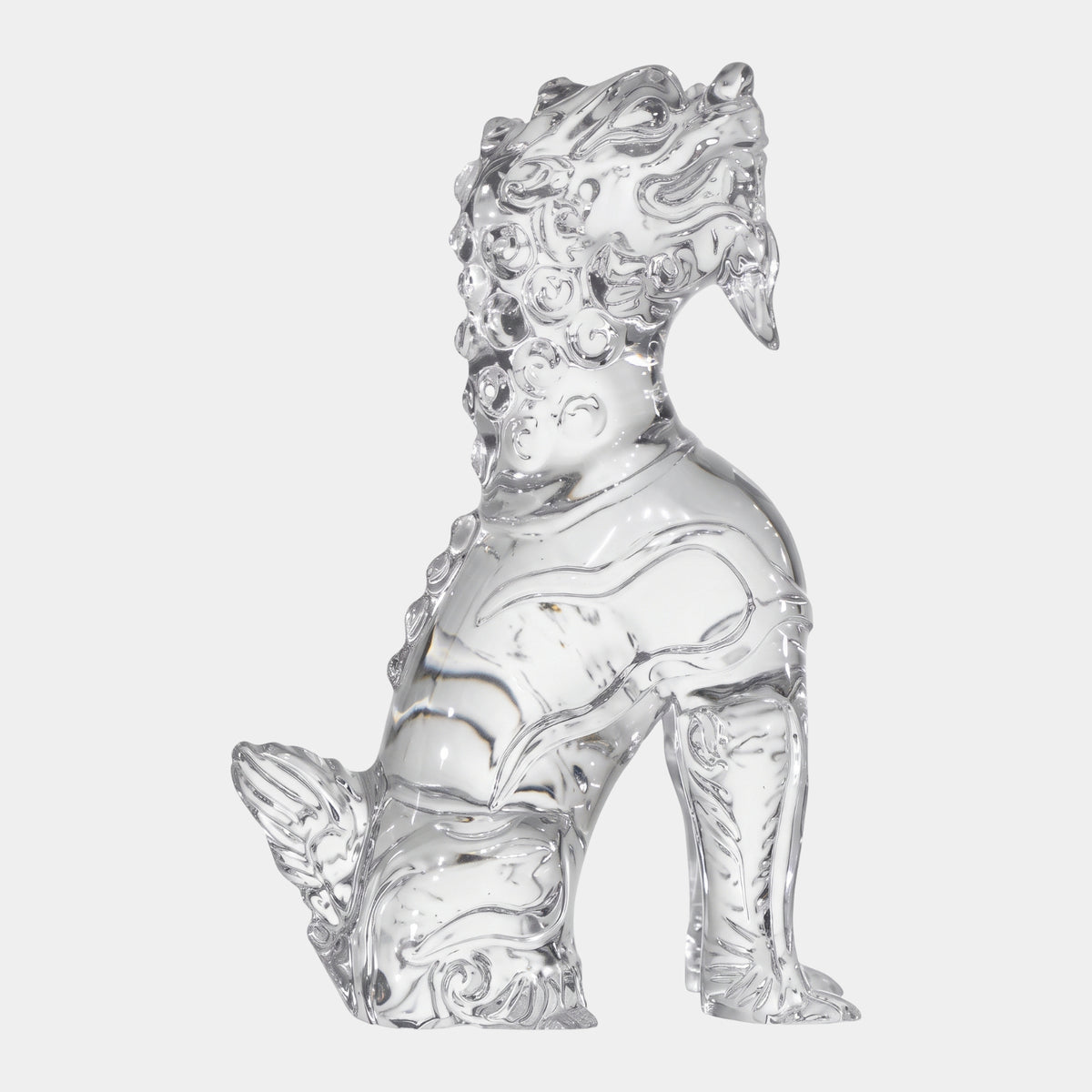 Clear Knob-Maned Beast Cast Resin Sculpture, 27cm, seated upright with curled knob mane and scrolled tail plume, clear resin finish, on a plain white background.