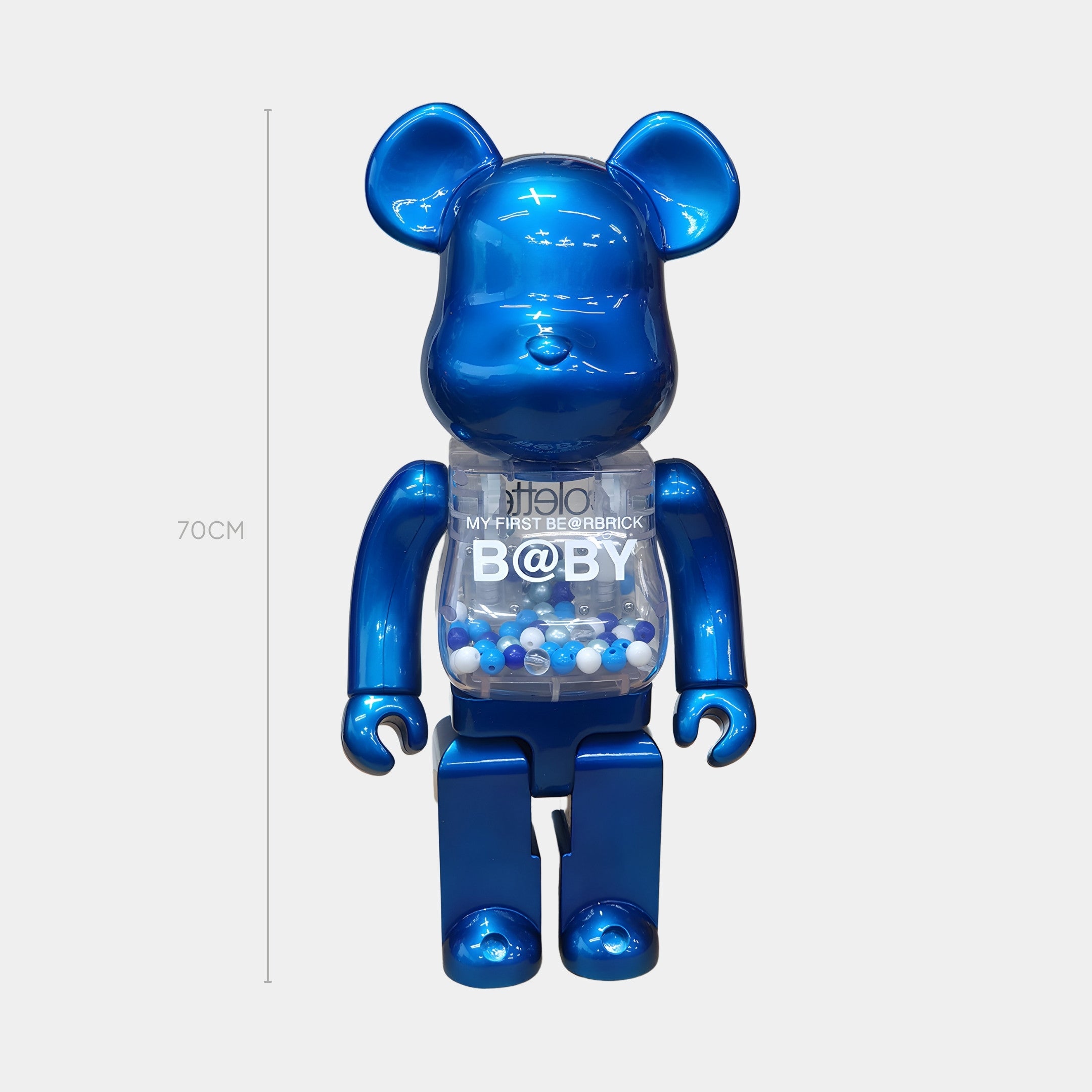 The Sapphire Blue Beads Bear Sculpture - 70cm by Giant Sculptures stands upright with a transparent torso full of sapphire blue beads and white-gray balls, plus MY FIRST BE@RBRICK B@BY text—a jewel-toned centerpiece for any space.