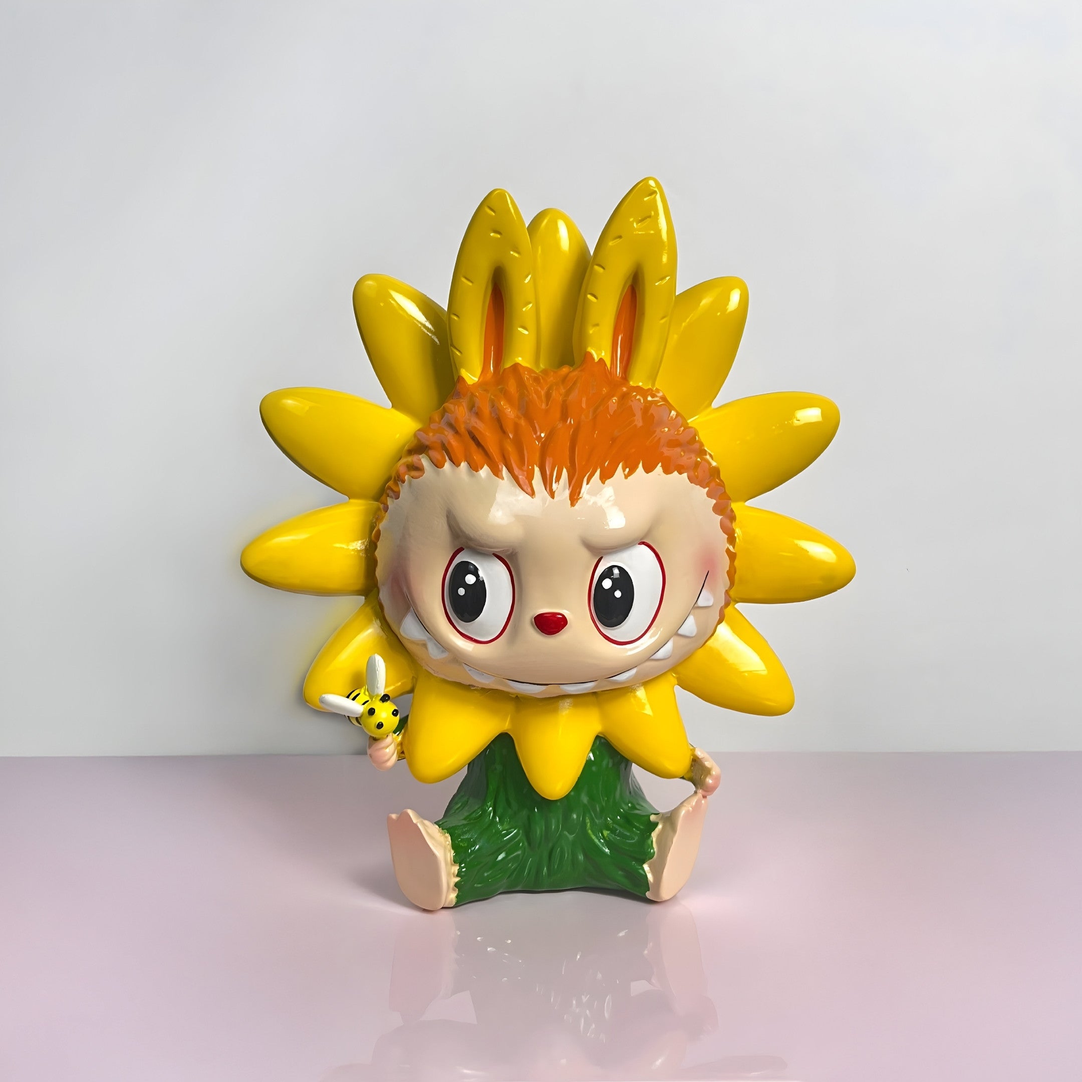 The 100cm Flower Elves Sunflower Labubu Sculpture by Giant Sculptures features a sunflower-headed character with orange hair, bunny ears, big red and white eyes, green shorts, and a small bee toy.