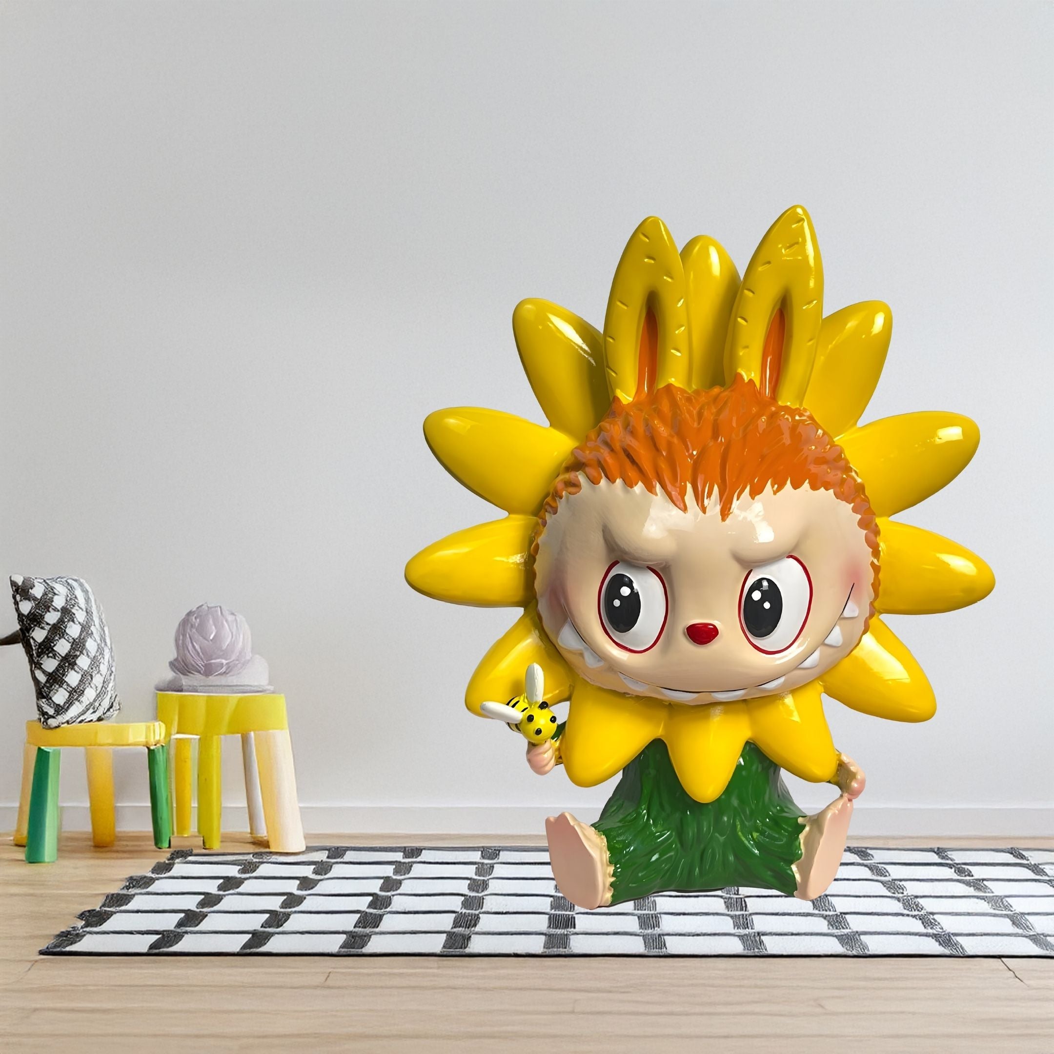 The Flower Elves Sunflower Labubu Sculpture - 160cm by Giant Sculptures, with hand-painted petals, orange hair, and big eyes, sits on a checkered rug in a modern minimal living room with small chairs and a decorative flower.