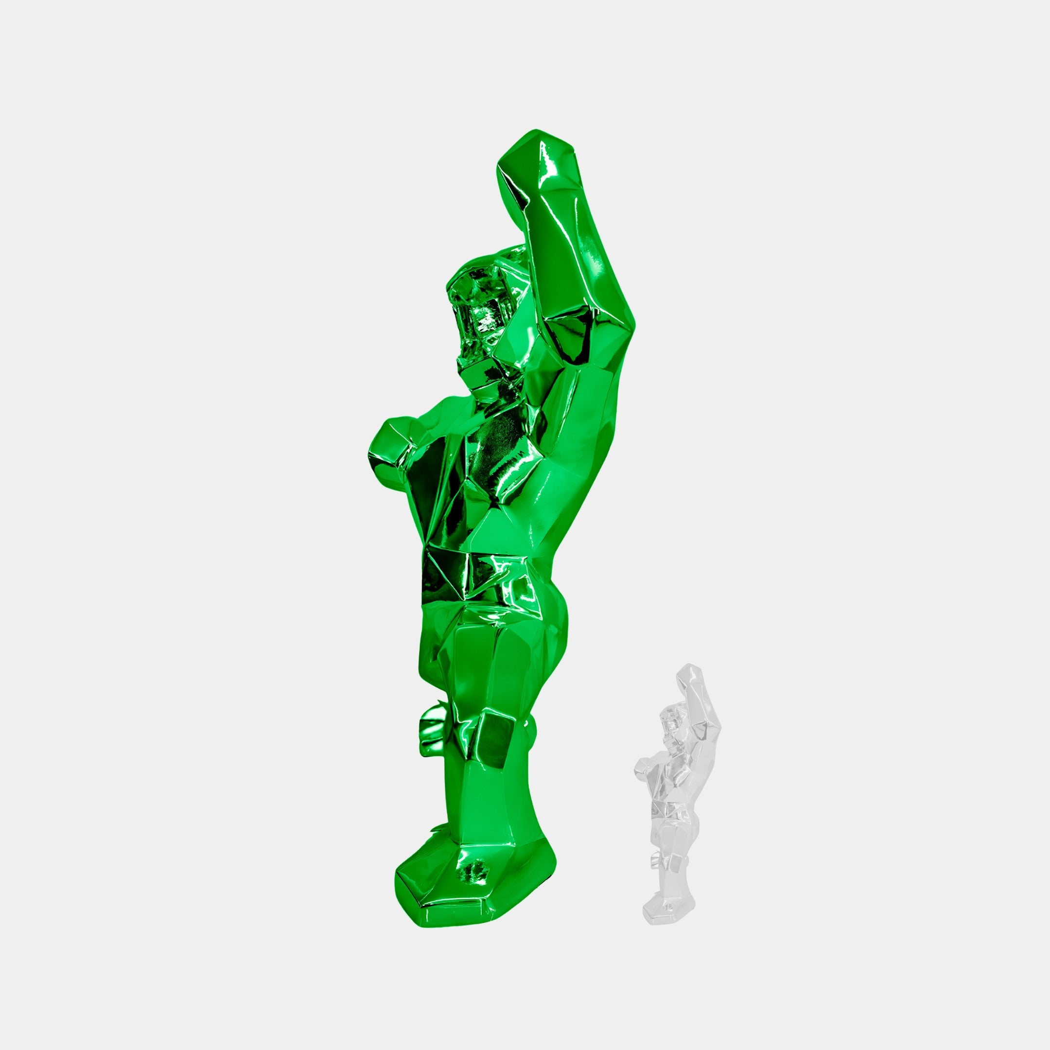 The Forrest Green Gorilla Sculpture - 165cm by Giant Sculptures, with its arm raised, showcases nature-inspired elegance with a faceted design. A smaller white statue complements it in the background, creating a perfect modern aesthetic against a simple white backdrop.