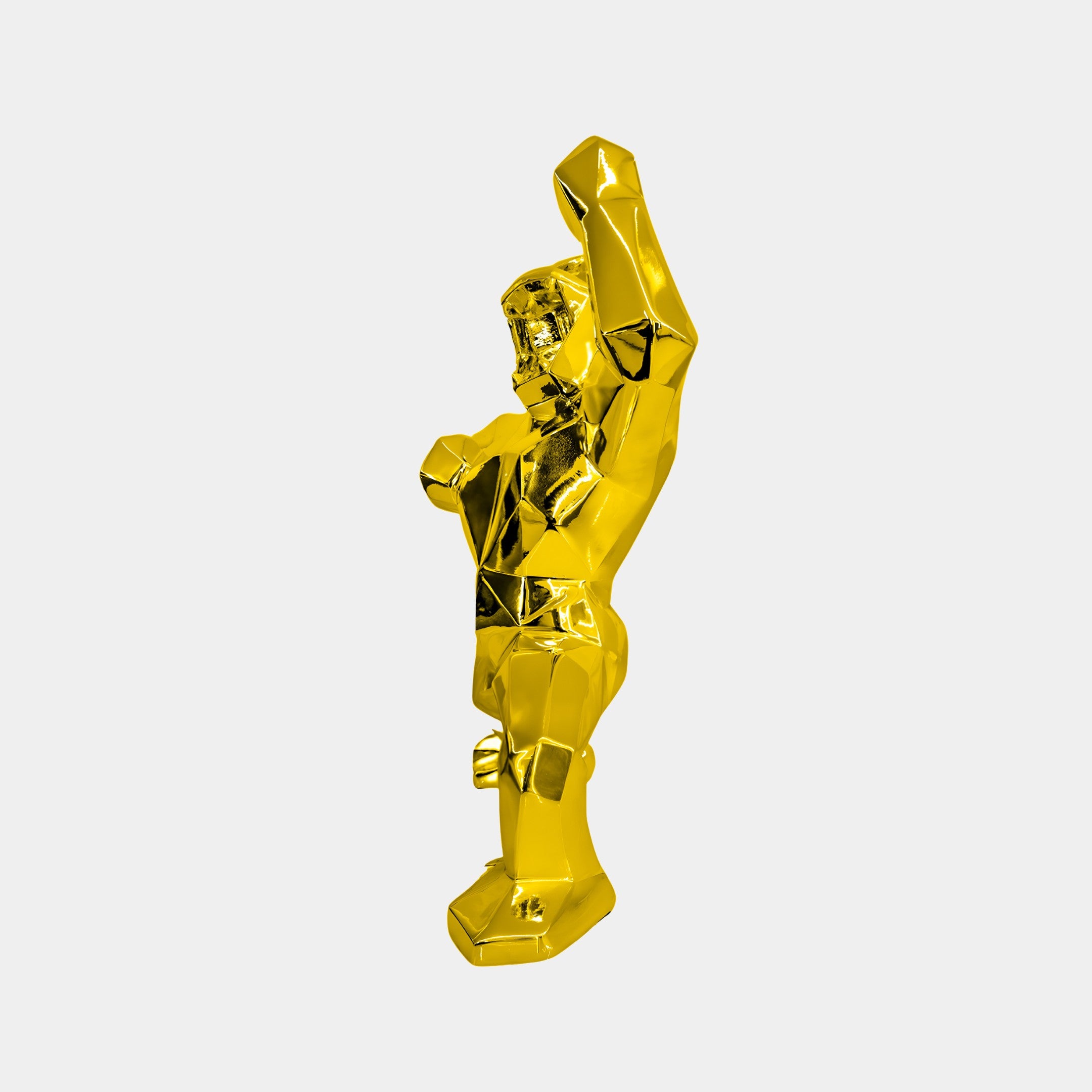 The Gilded Gold Gorilla Sculpture – 50cm by Giant Sculptures features a golden, abstract muscular form with a raised arm. Its angular design contrasts beautifully against a plain white background, making it a perfect choice for luxury interior decor enthusiasts.