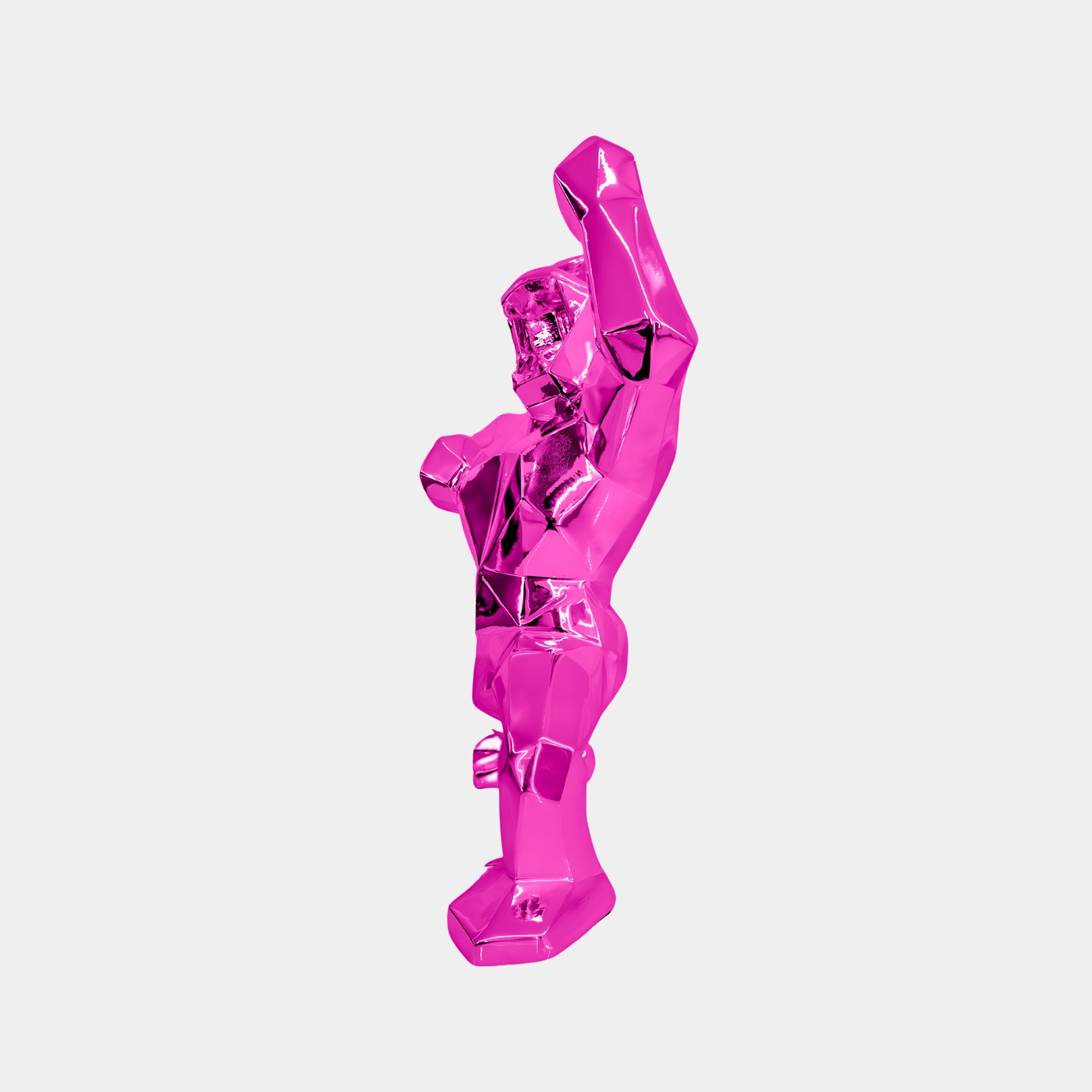 The Flamingo Pink Gorilla Sculpture by Giant Sculptures is a 50cm piece crafted from premium resin with a geometric surface. It stands upright, one arm raised and the other bent at the elbow, embodying contemporary arts abstract design against a plain white background.