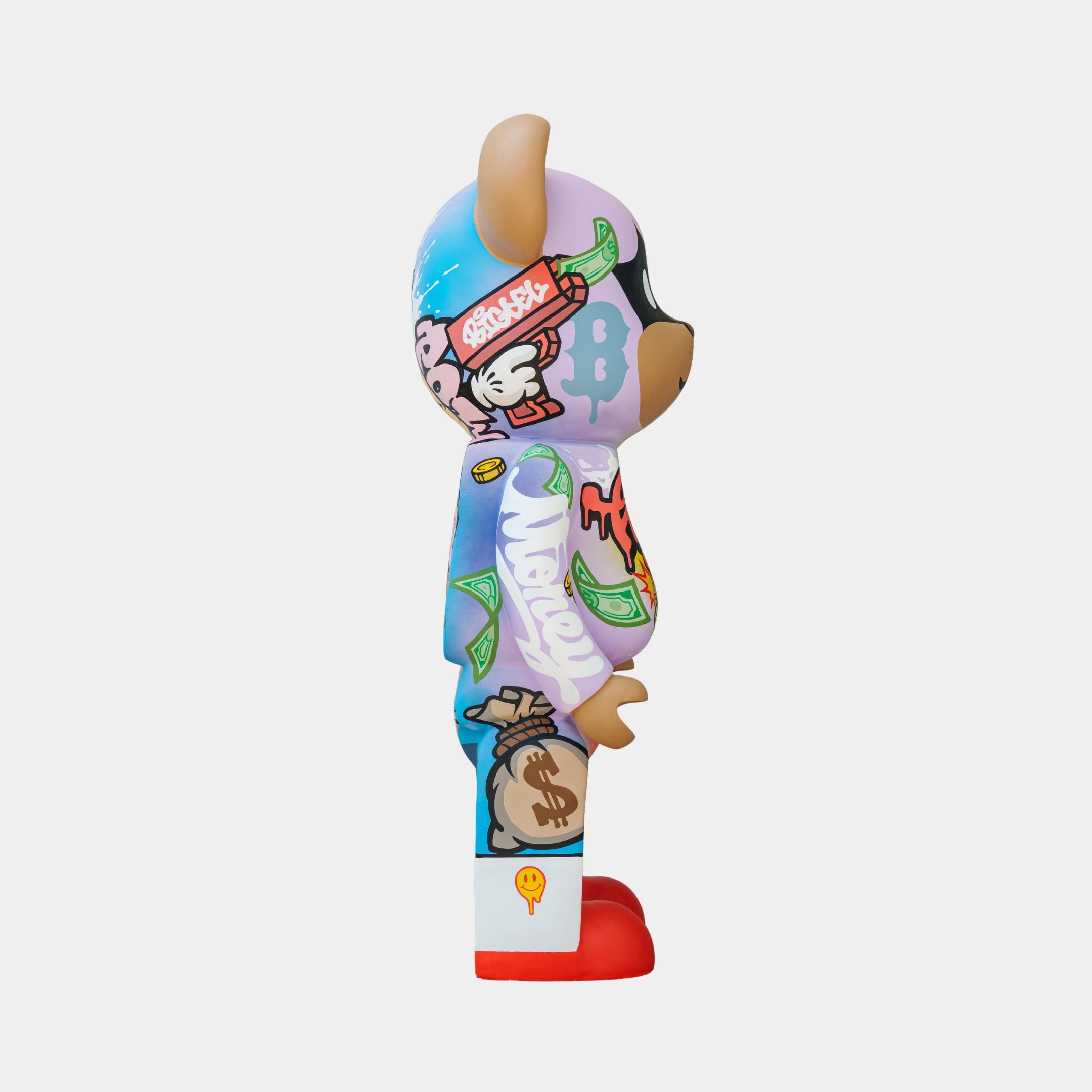 The Lucky Paws Bear Sculpture by Giant Sculptures, a vibrant vinyl figure standing 50cm tall, features graffiti and pop art elements like dollar bills and wings. With red shoes and an abstract, playful look, this limited edition piece is perfect for collectors.