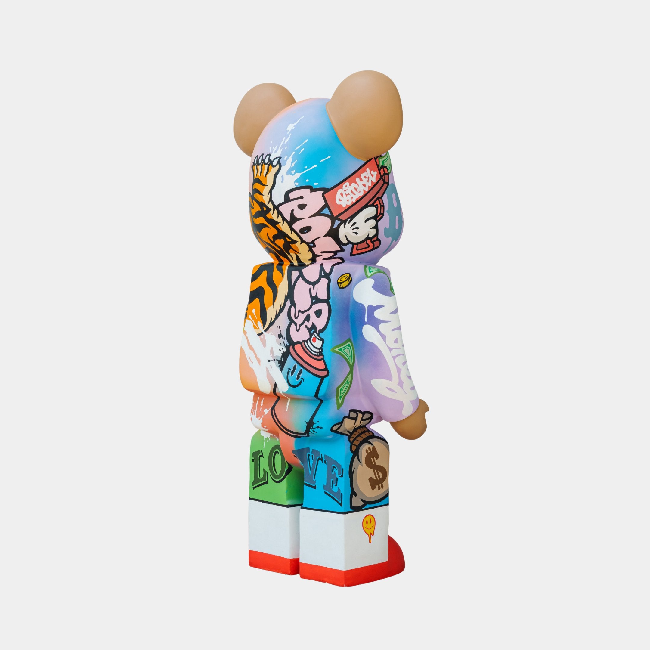 The Lucky Paws Bear Sculpture by Giant Sculptures is a 50cm collectible, boasting graffiti-style art with vibrant patterns, letters, the word LOVE, money symbols, and abstract designs in bold hues.