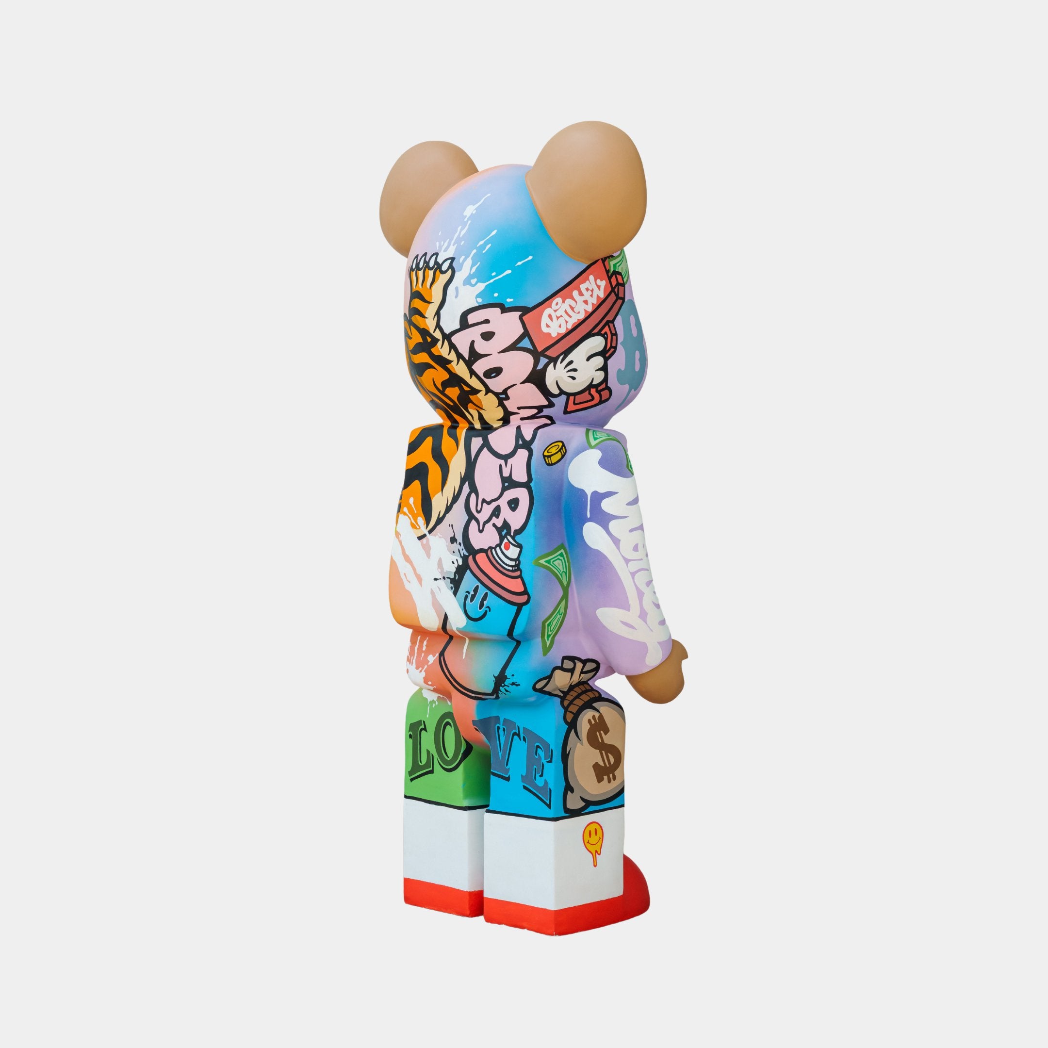 Set against a plain backdrop, the Giant Sculptures Lucky Paws Bear Sculpture - 135cm dazzles with street art flair, featuring cartoon characters, bold patterns, and symbols of prosperity and protection in a vibrant and captivating design.