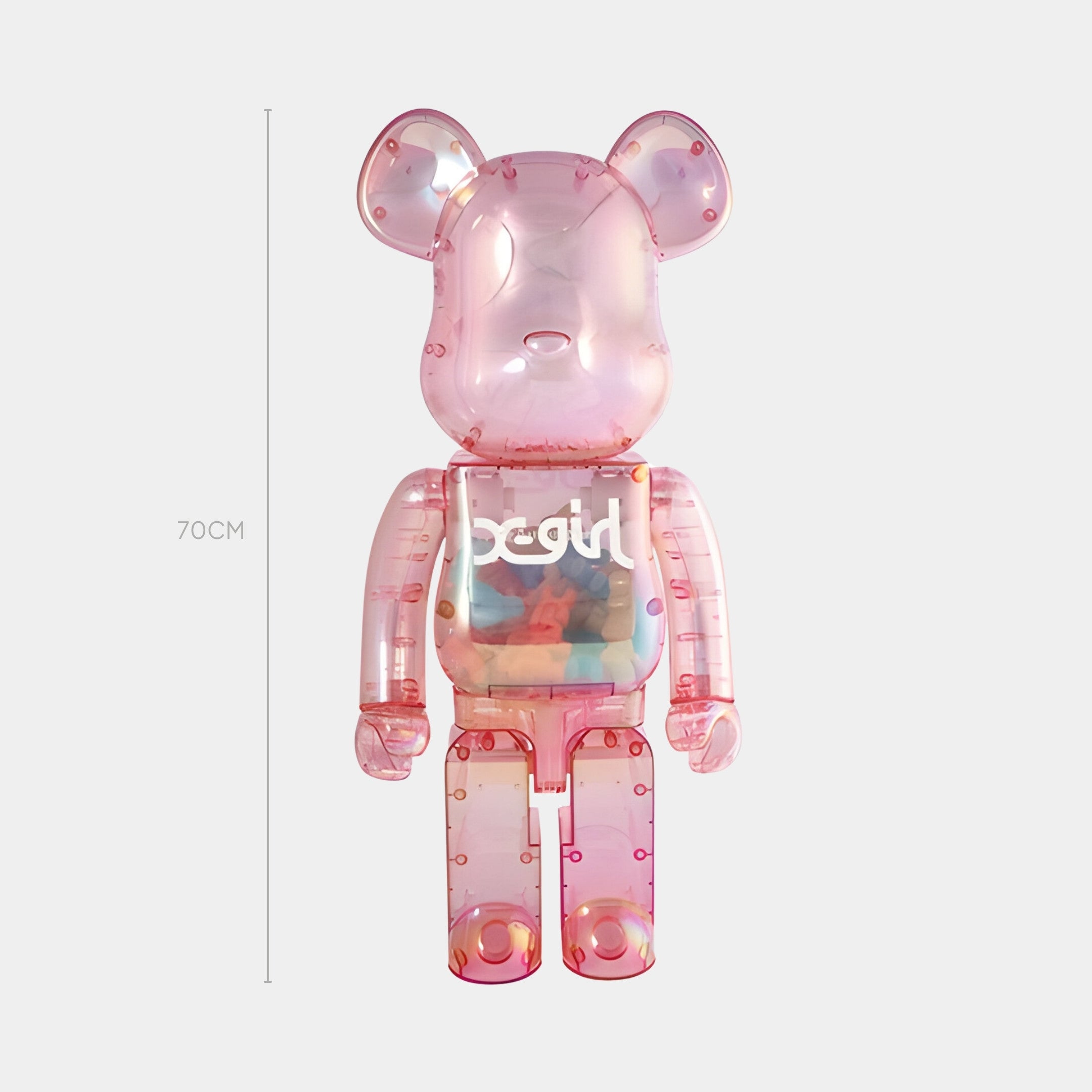 The Transparent Pink Bear Sculpture - 70cm by Giant Sculptures features soul on its chest, colorful objects inside its torso, and a light grey background—ideal for contemporary interiors.