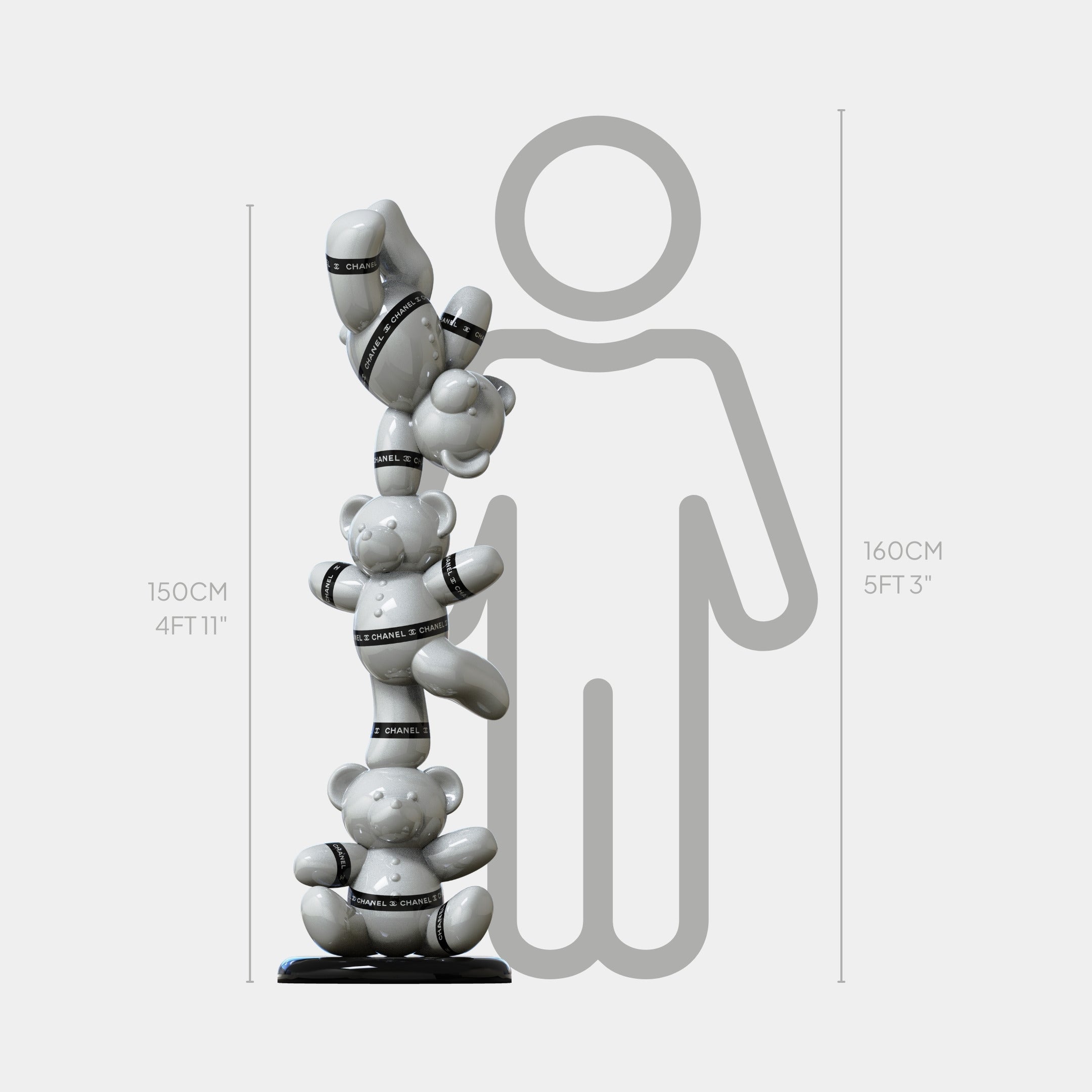 The Gacko Chanel Triple Bear Sculpture by Giant Sculptures stands 150 cm tall, featuring stacked bears with black straps beside a person outline—a bold, fashion-inspired statement for contemporary interiors.