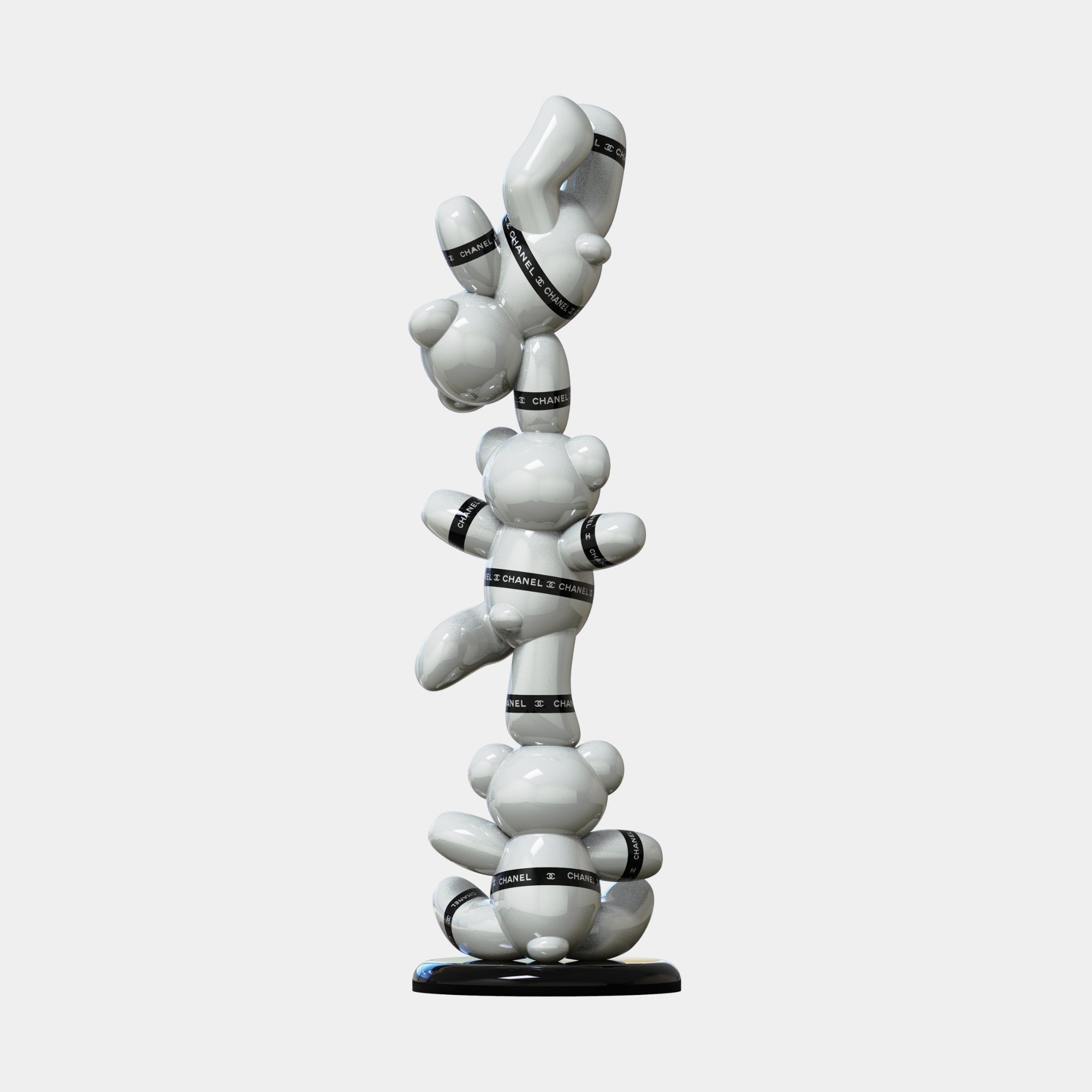 The Gacko Chanel Triple Bear Sculpture by Giant Sculptures features three glossy white bears stacked vertically with black CHANEL bands on a sleek black base, creating a striking 90cm luxury decor piece.