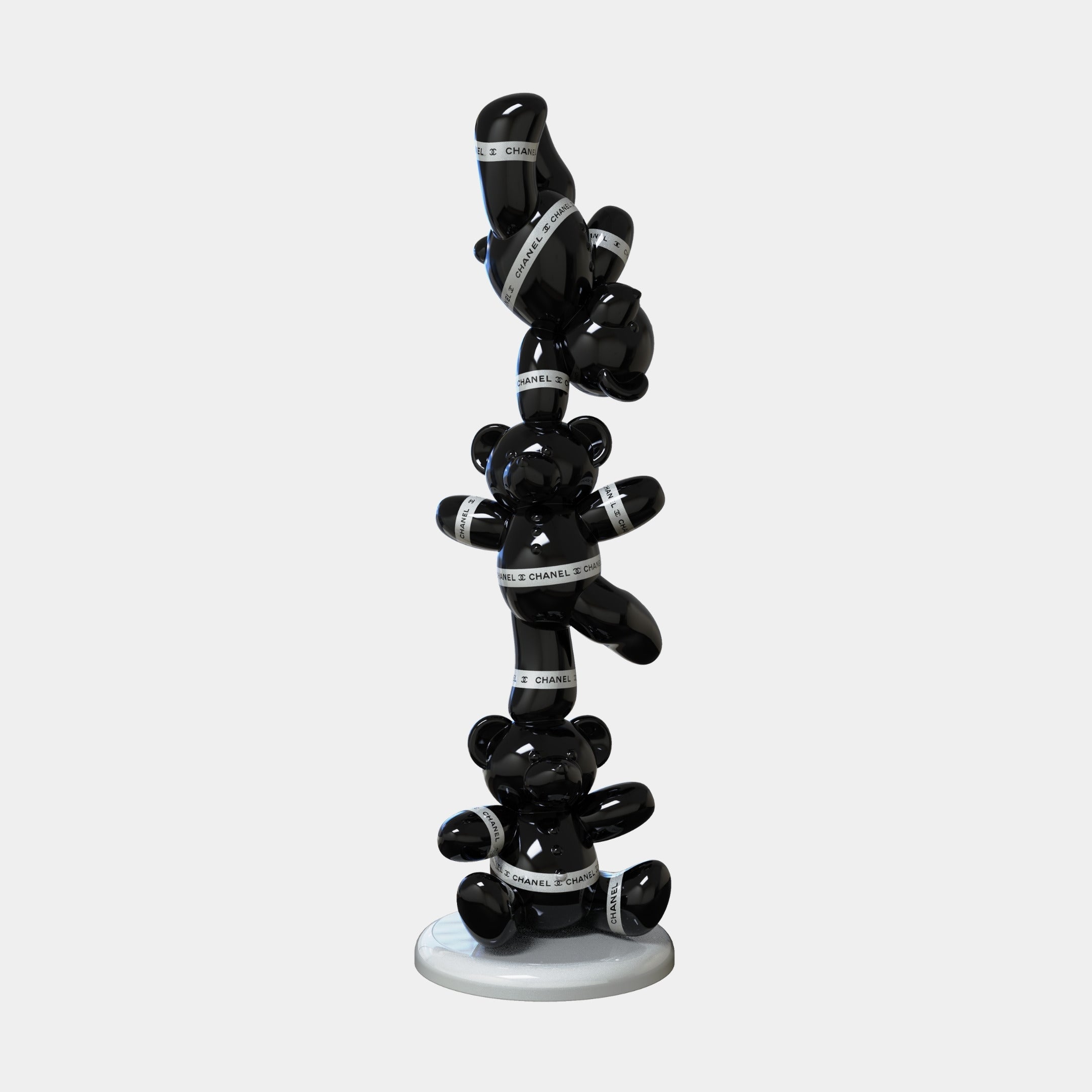 The Gacko Black Chanel Triple Bear Sculpture by Giant Sculptures stands 90cm tall, featuring glossy stacked bears with white CHANEL ribbon, set on a round white base.