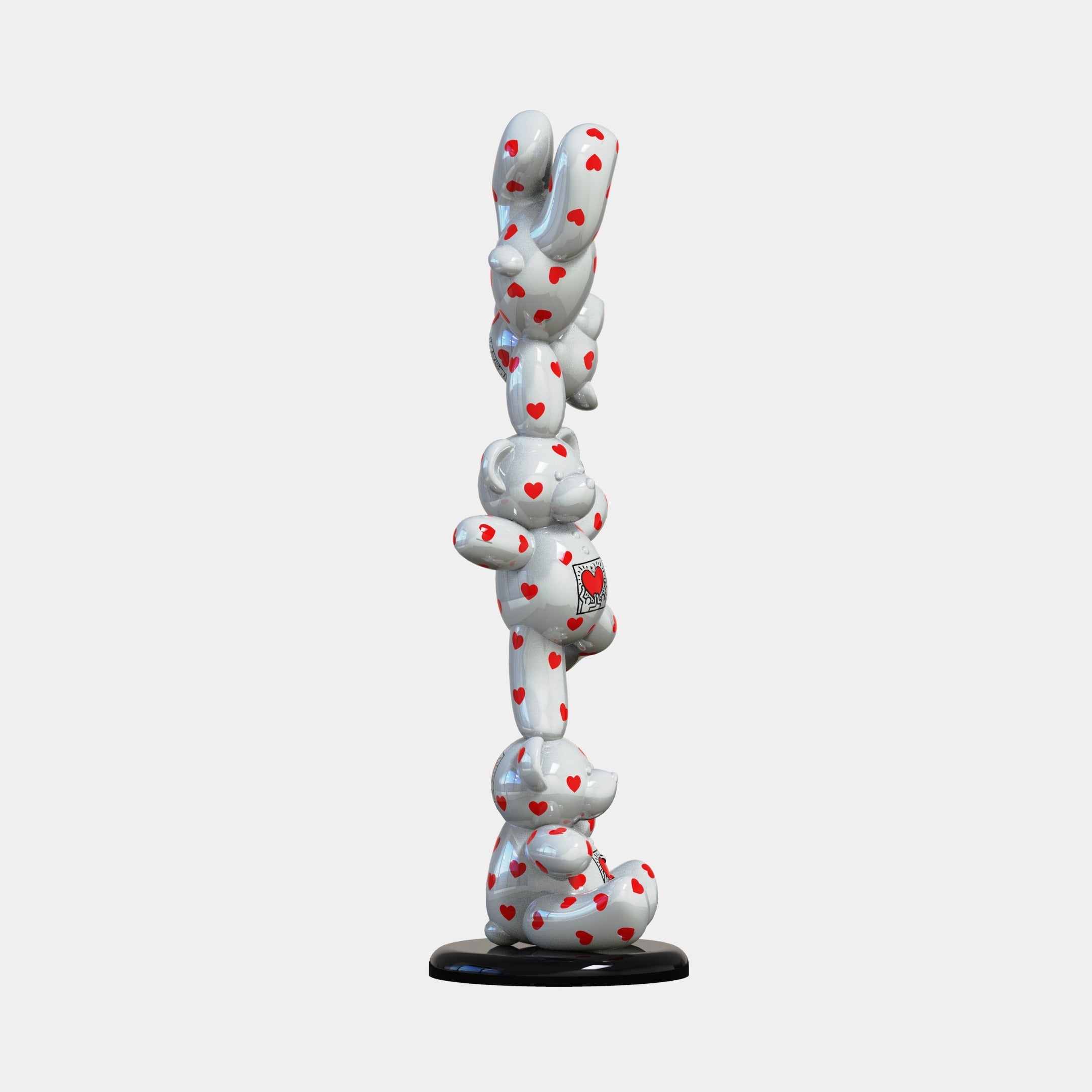 The Gacko Keith Love Triple Bear Sculpture by Giant Sculptures (90cm) showcases three white teddy bears with red hearts stacked vertically on a black circular base, creating a striking contemporary artwork.