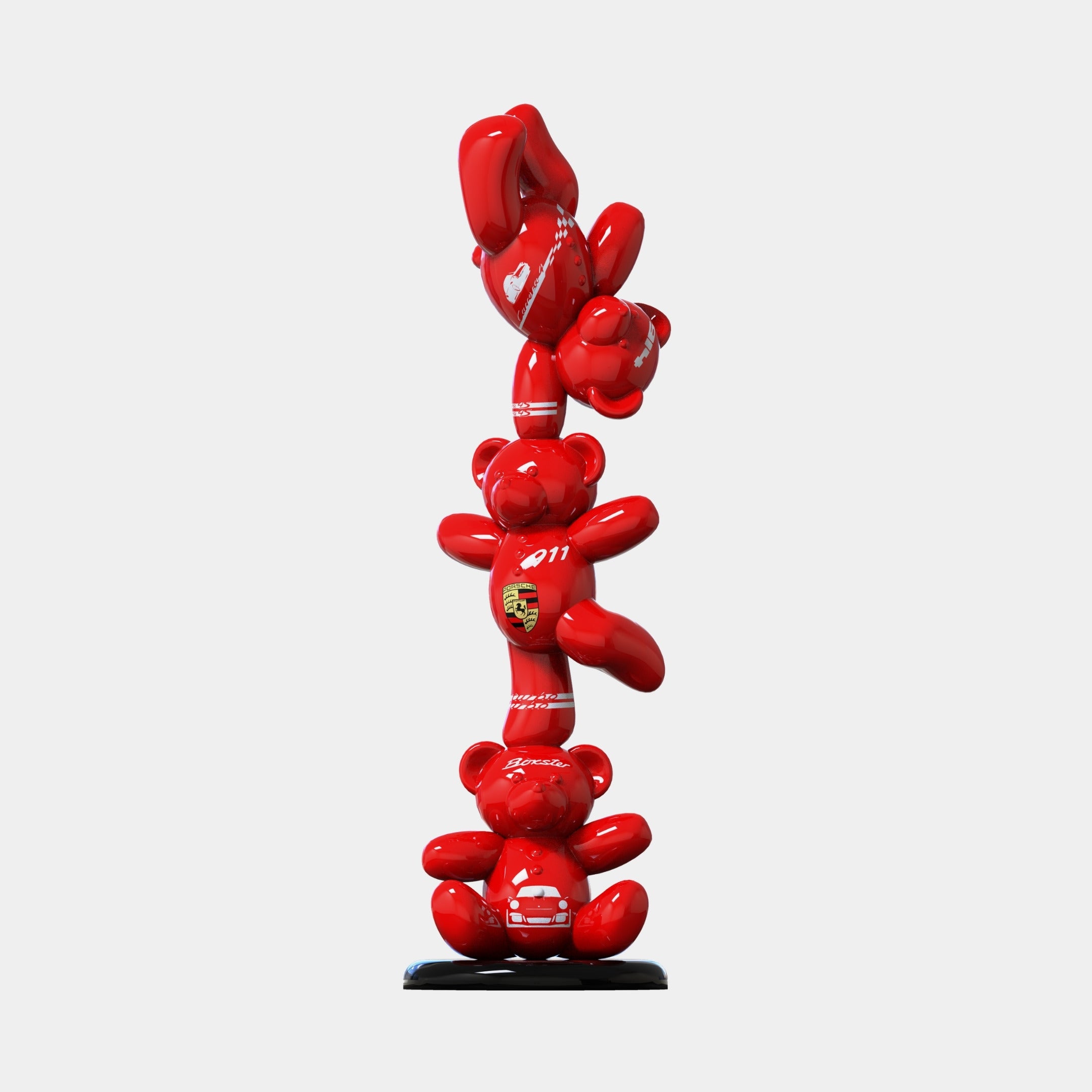 The Gacko Porsche Triple Bear Sculpture by Giant Sculptures is a 90cm tall vertical pop artwork of shiny red bears stacked atop each other, adorned with racing decals and hearts, on a small round black base against a white background.