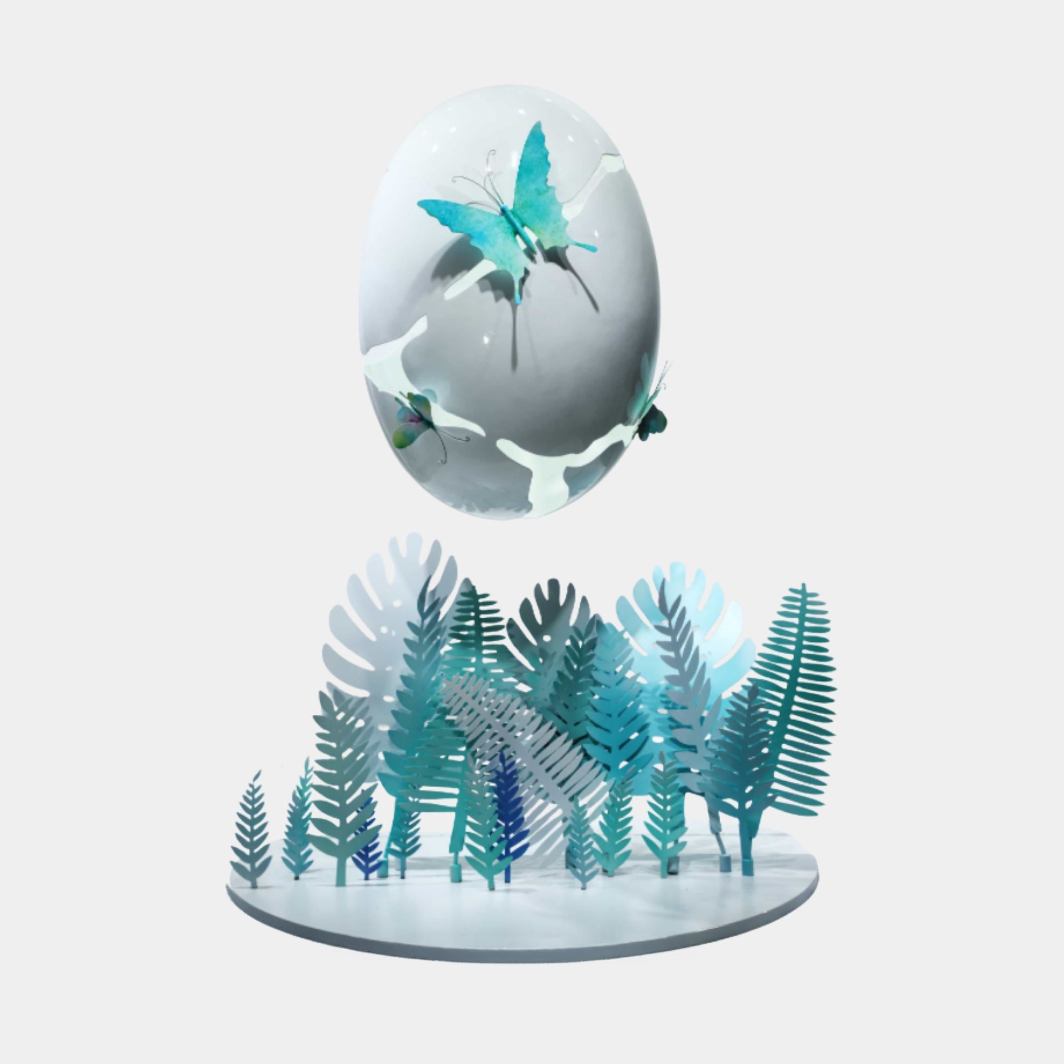 Giant Sculptures Butterfly Egg & Fern Garden wrought iron installation, 88cm, with a suspended egg and turquoise butterflies above teal cut-metal ferns on a light background.
