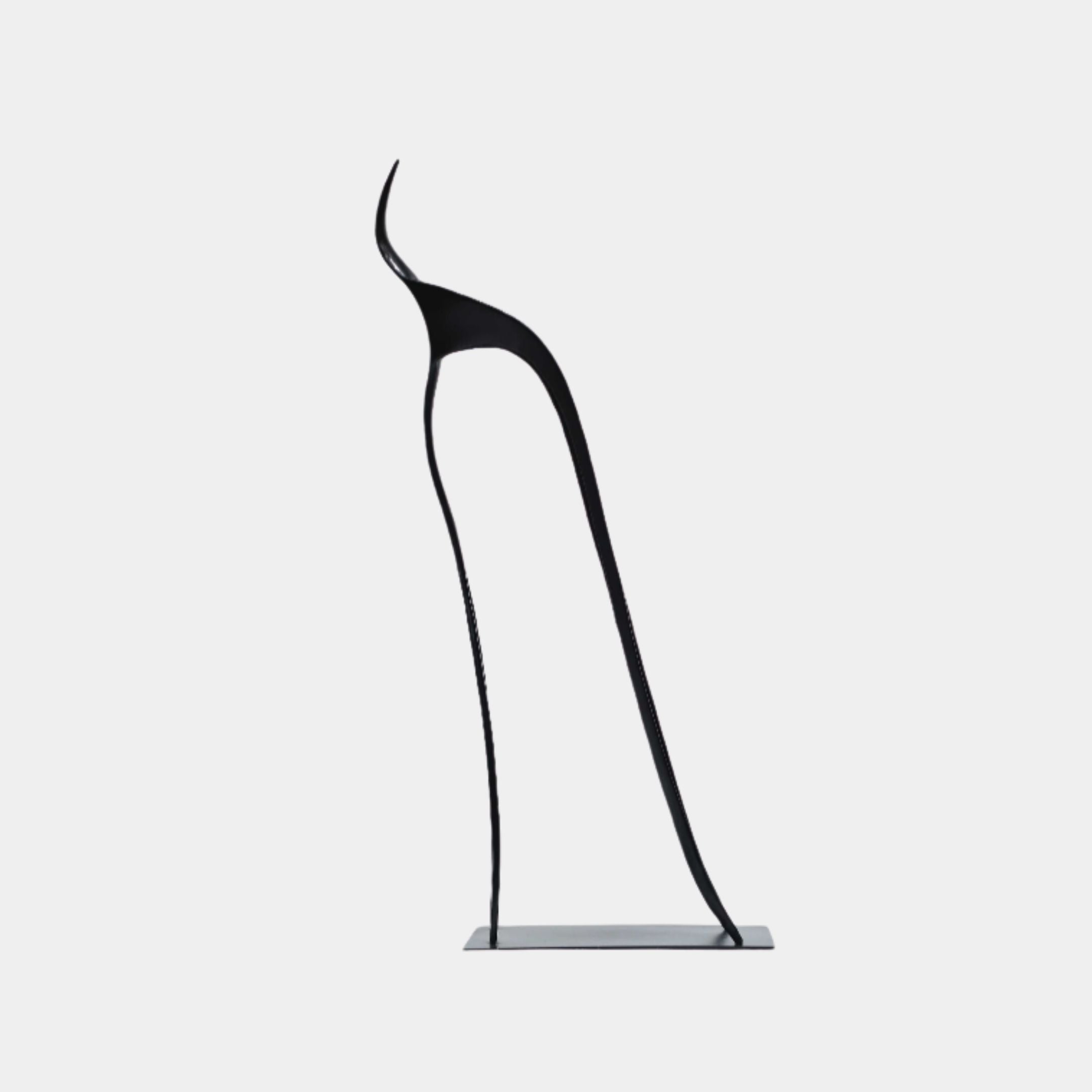 Black Minimalist Standing Form Metal Sculpture by Giant Sculptures, 65cm tall abstract figure in matte black with elongated legs on a flat rectangular base.