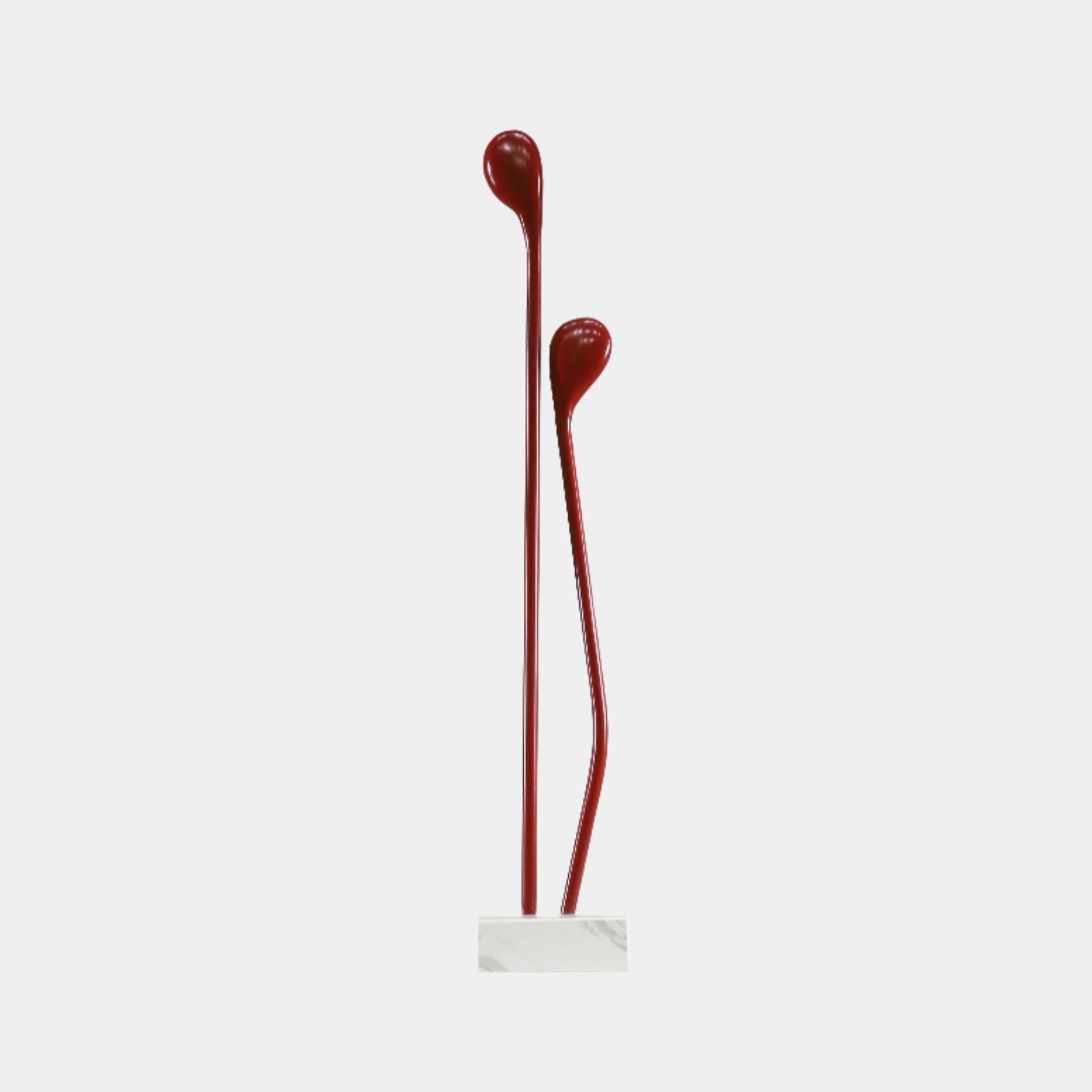 Red Twin Fluid Abstract Teardrop Metal Sculpture by Giant Sculptures, two deep red stems with droplet tops on a white marble base, against a plain background.