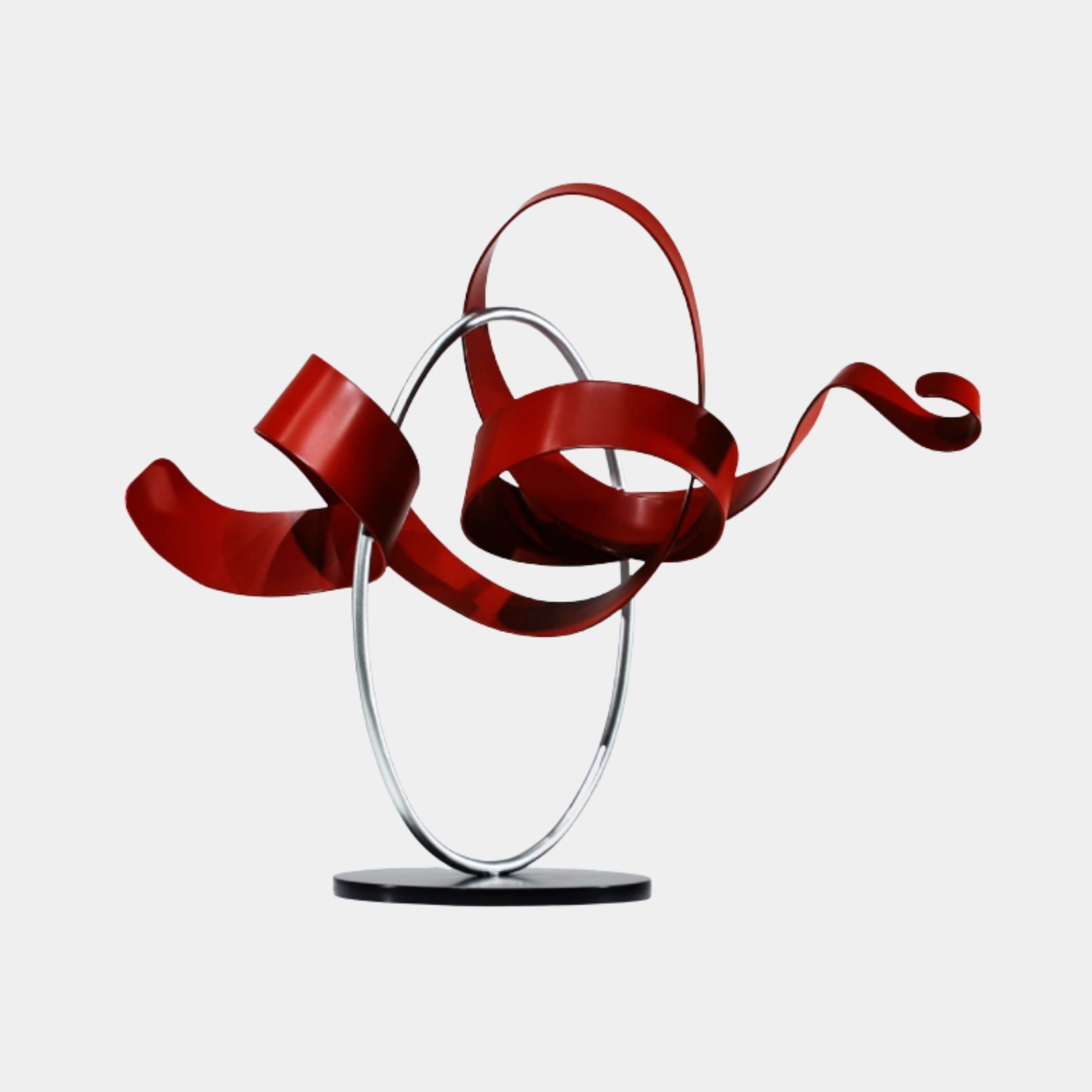 Giant Sculptures Red & Silver Abstract Ribbon Stainless Steel Sculpture 68cm, matte red coiled ribbons looping through a polished silver oval ring on a black base.