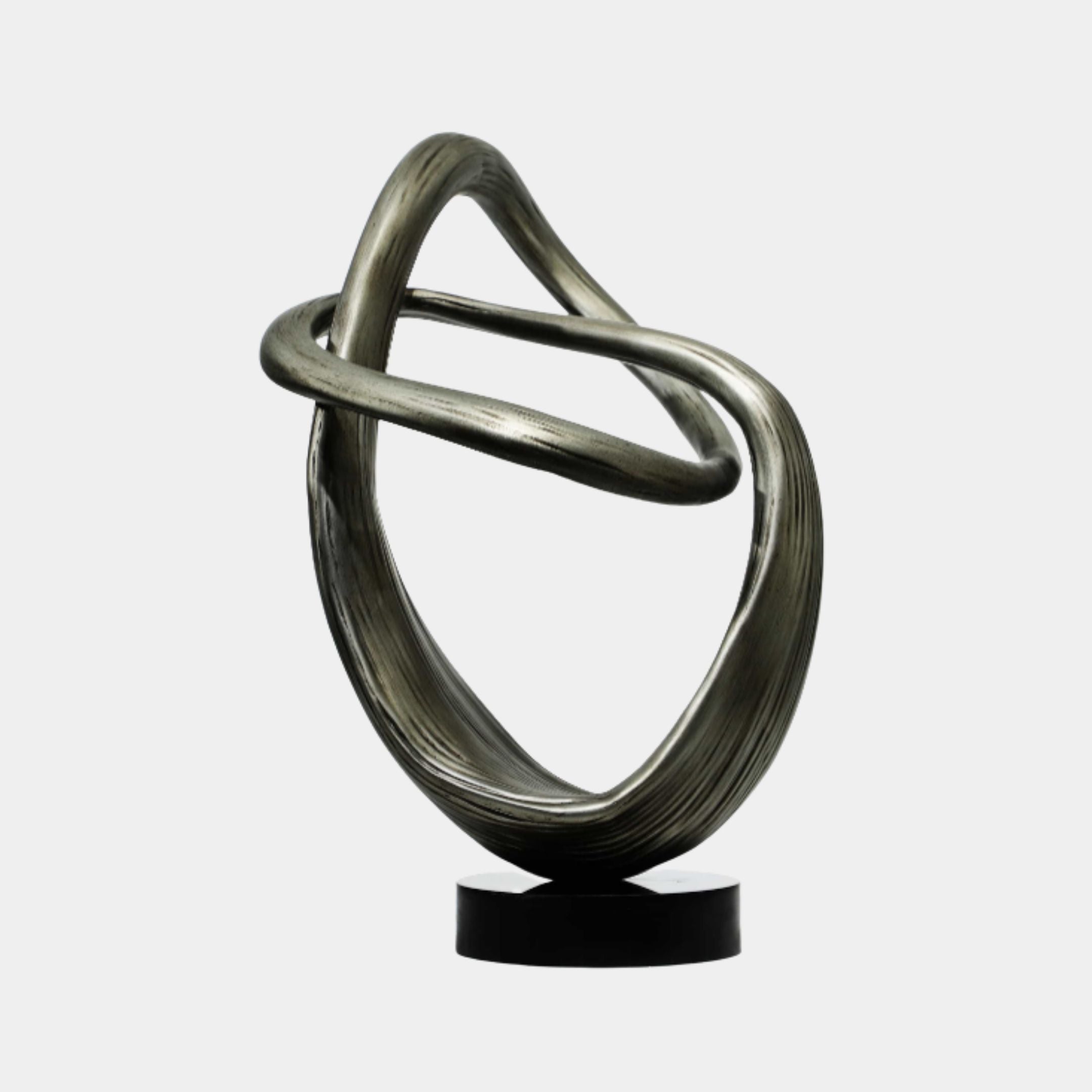 Brushed Silver Abstract Knot Metal Sculpture 70cm by Giant Sculptures, a continuous looping ribbon form on a round black base against a plain light background.