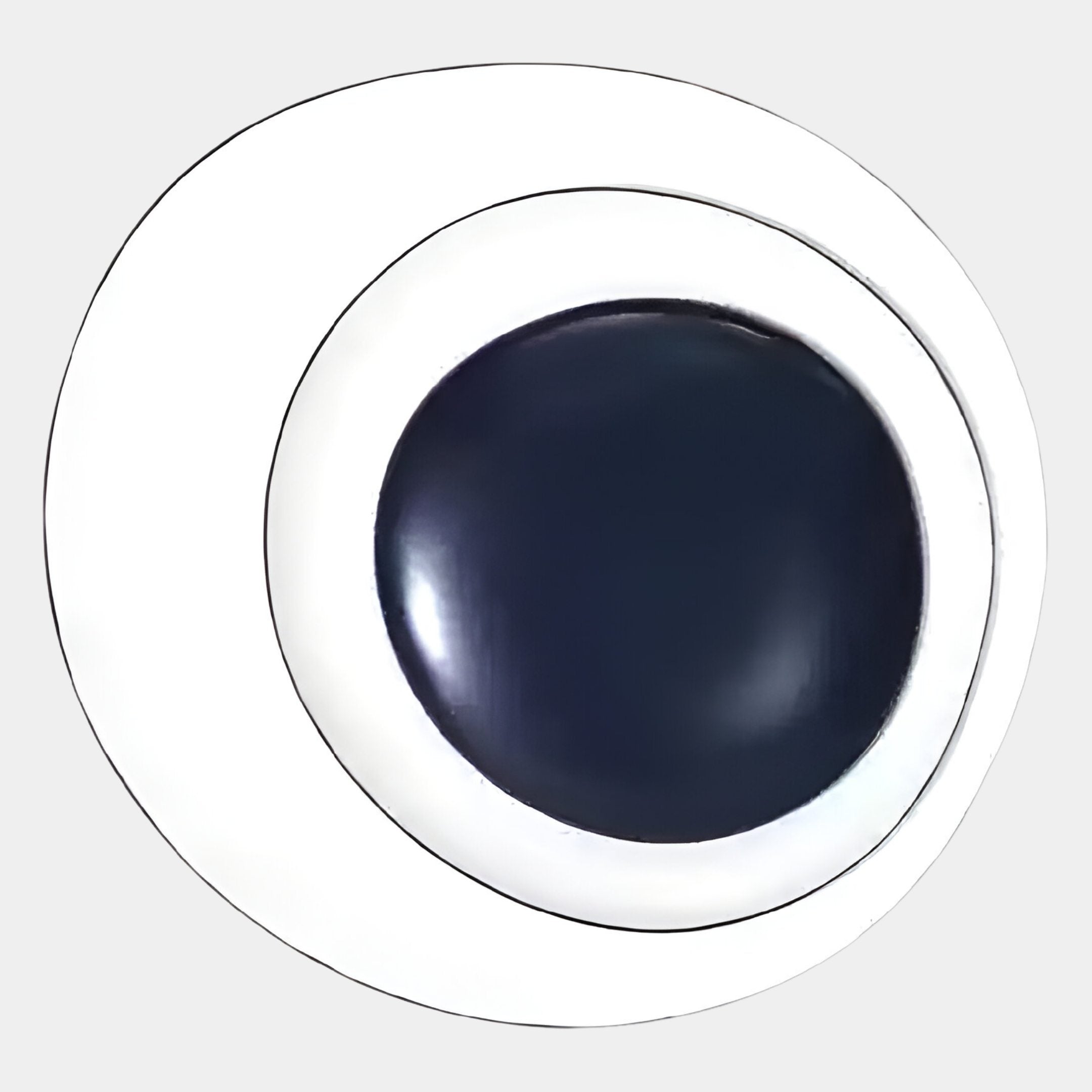 A close-up of the Aetherial Midnight Blue Glossy Circular Asymmetry 3D Wall Art by Giant Sculptures, showcasing its striking black and white eye design with a centered movable pupil on a light gray background.