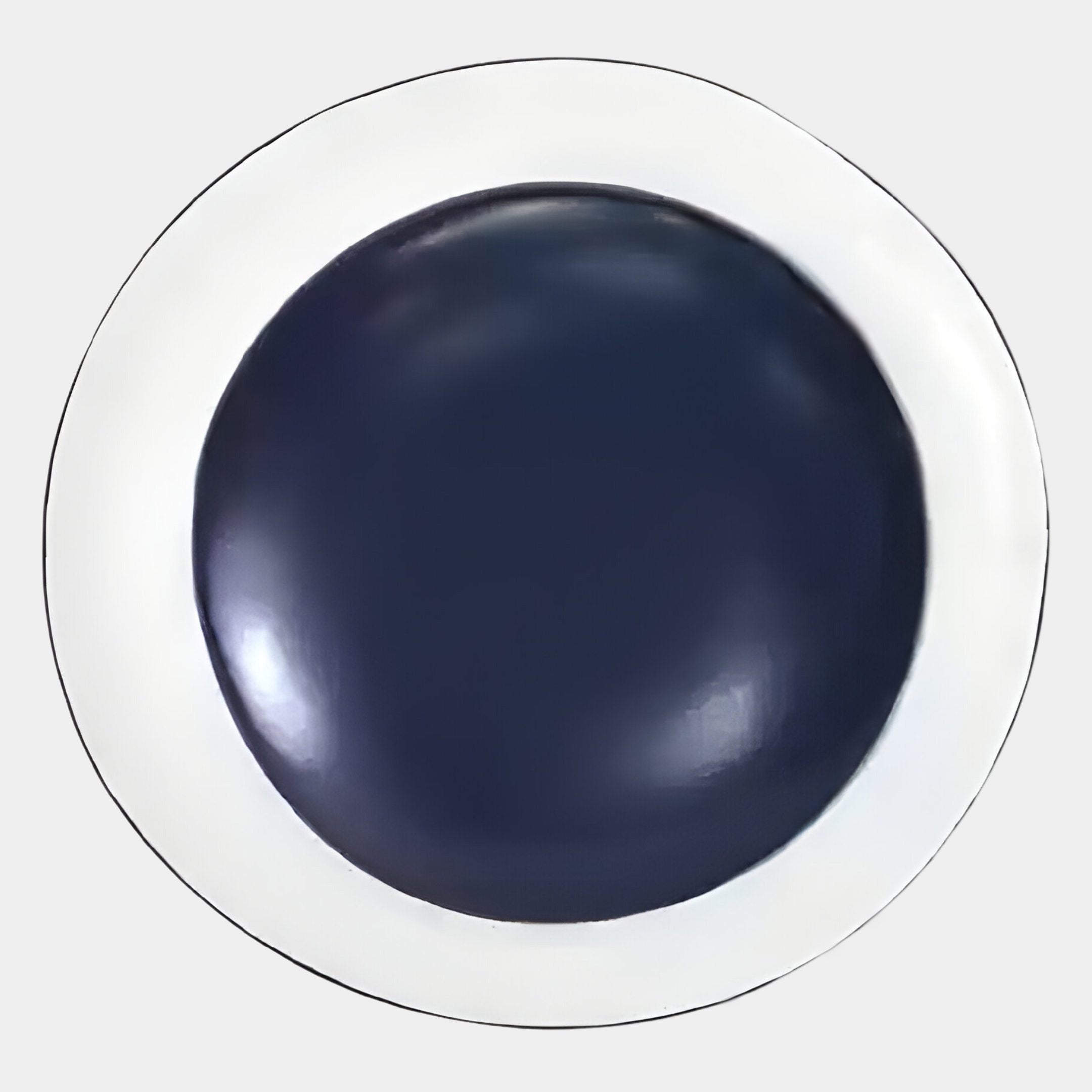 A round white plate displays the Giant Sculptures Aetherial Midnight Blue Glossy Circular Symmetry 3D Wall Art, viewed from above against a plain light background.