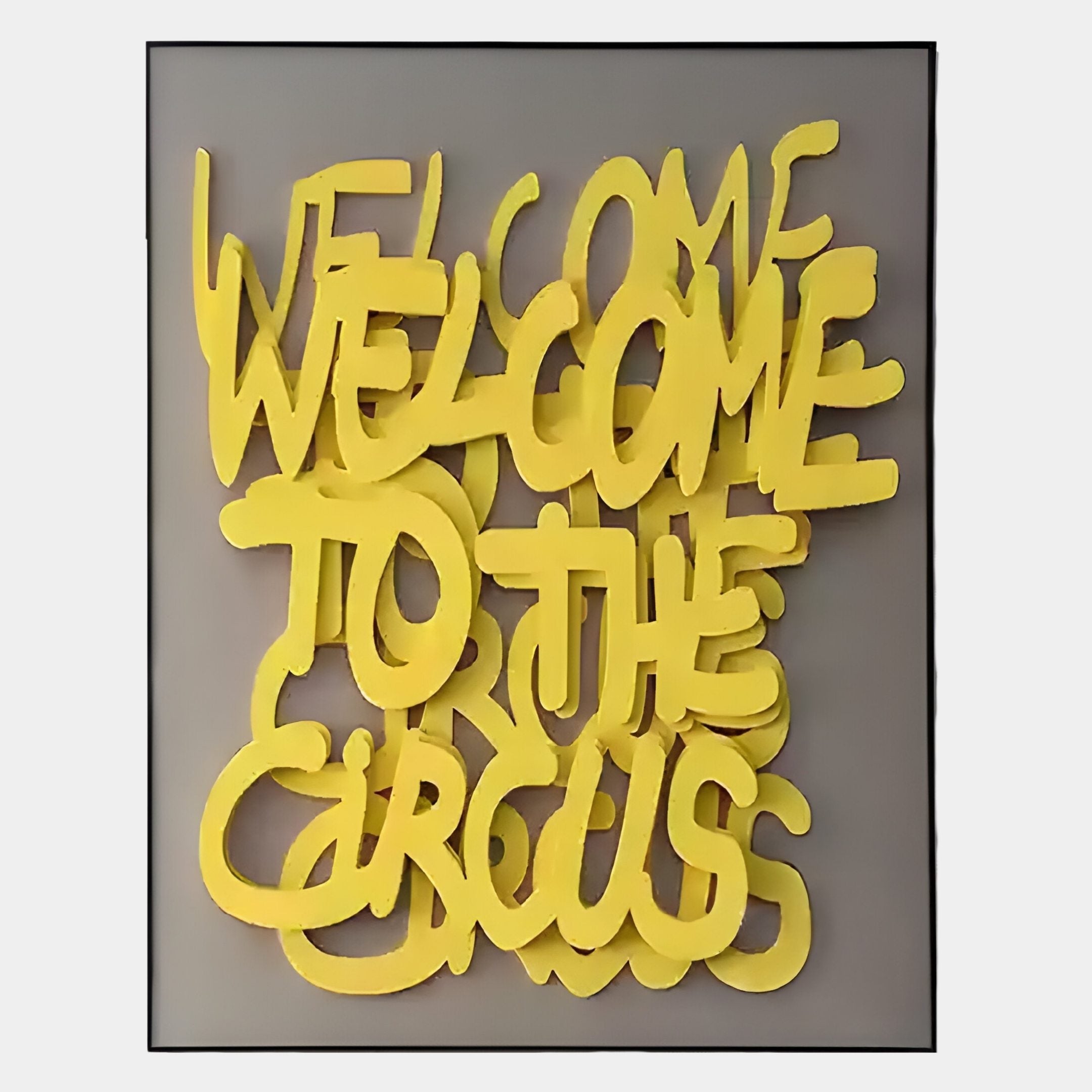 Urbanic Yellow Welcome Script 3D Wooden Graffiti Wall Art by Giant Sculptures features bold, overlapping yellow graffiti text reading WELCOME TO THE CIRCUS on a gray background with a thin black frame—ideal for lovers of street art décor.