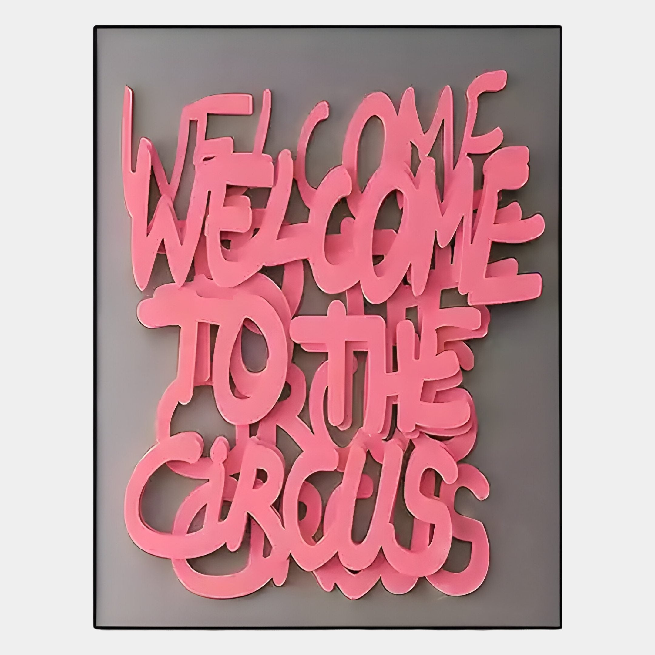 The Urbanic Pink Welcome Script 3D Wooden Graffiti Wall Art by Giant Sculptures features bright pink, overlapping graffiti-style text on gray with soft shadows and urban flair, spelling WELCOME WELCOME TO THE CIRCUS.