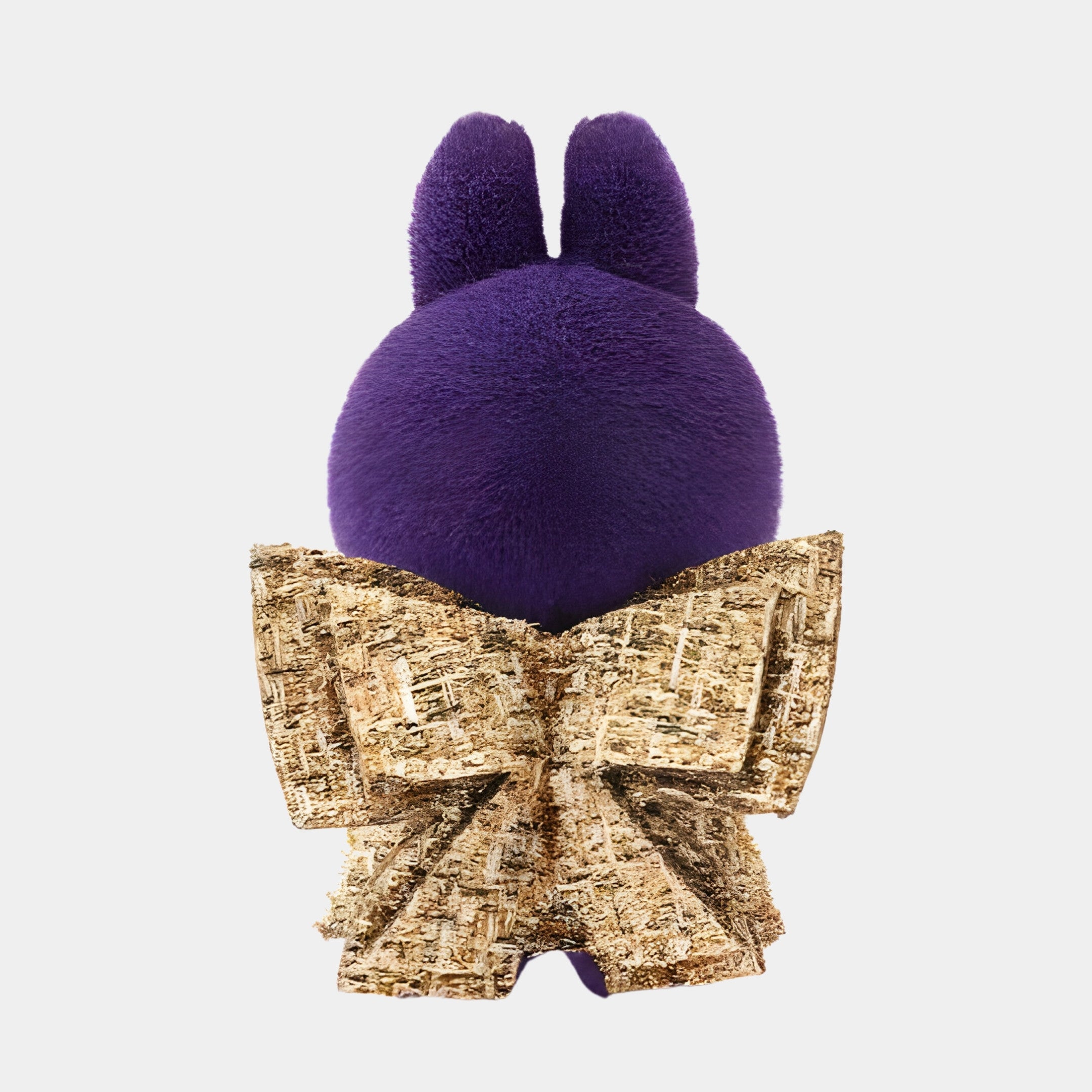 The Fortune Wings Purple Labubu Sculpture (100cm) by Giant Sculptures is a plush collectible with purple fur, bunny ears, and a large textured gold bow on its lower back, pictured from behind on a plain white background.