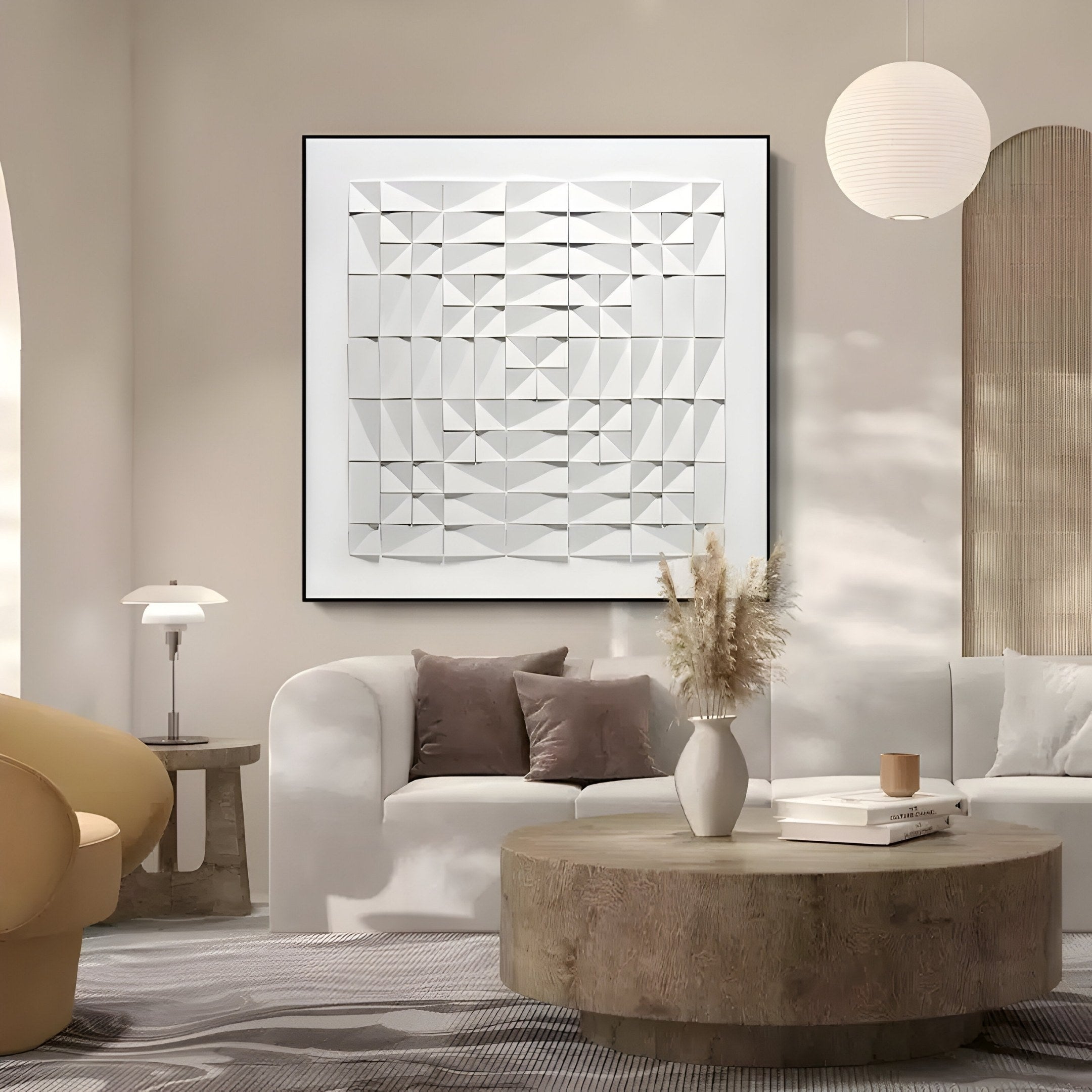 A modern living room with neutral tones features a white sofa, textured cushions, and a round wood coffee table with a vase of dried flowers. The inviting ambiance is enhanced by the Geometrica Spiral Matrix White 3D Wood Relief Wall Art from Giant Sculptures and soft lighting.