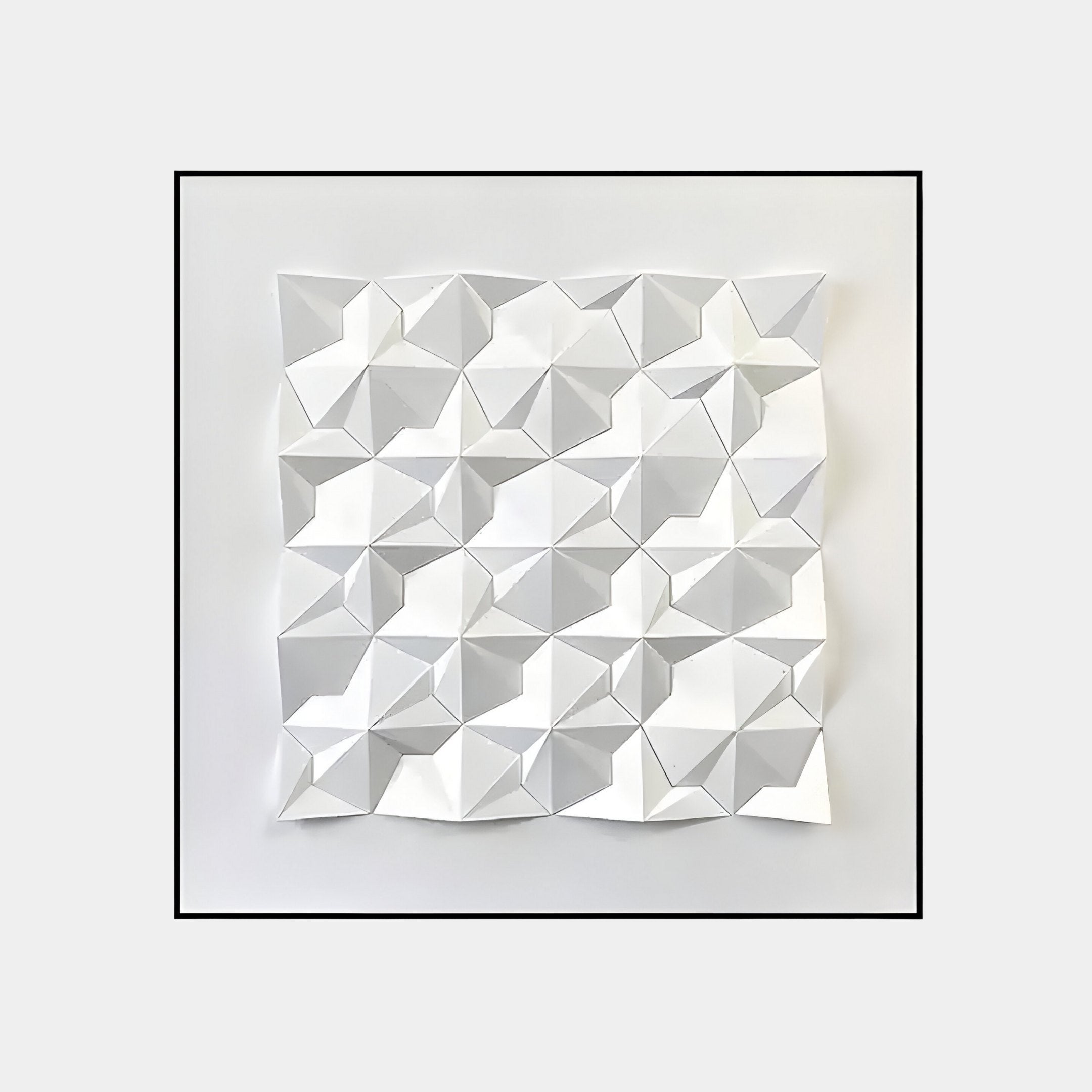 The Geometrica Tessellated Cube White 3D Wood Relief Wall Art by Giant Sculptures features folded white paper in a grid on a plain background, creating light and shadow effects that mimic the depth of a 3D wood relief.