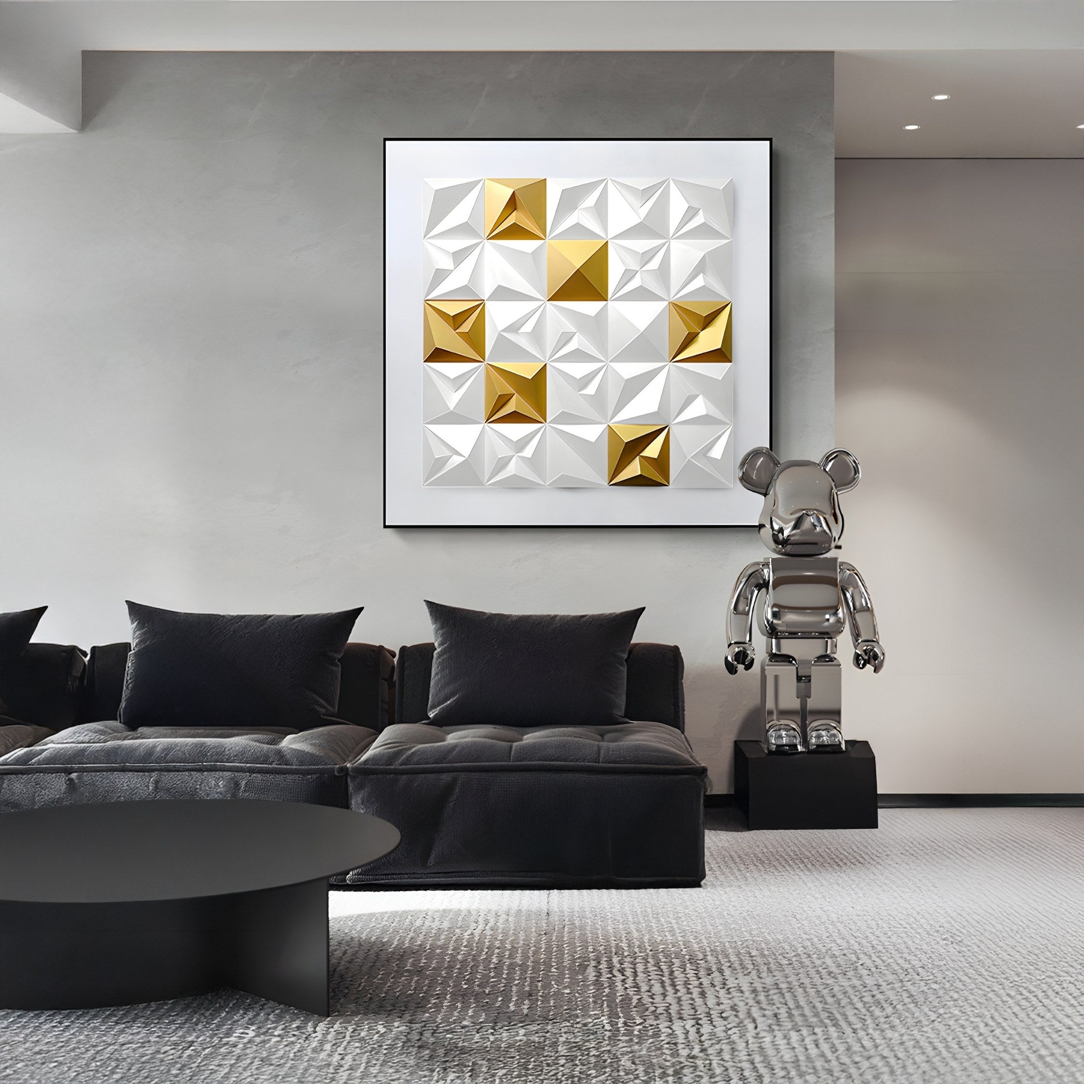 A stylish modern living room features a black sofa, a round table, and Geometrica White & Gold Accent 3D Wood Relief Wall Art. Nearby, a reflective metallic bear sculpture by Giant Sculptures stands on a pedestal.