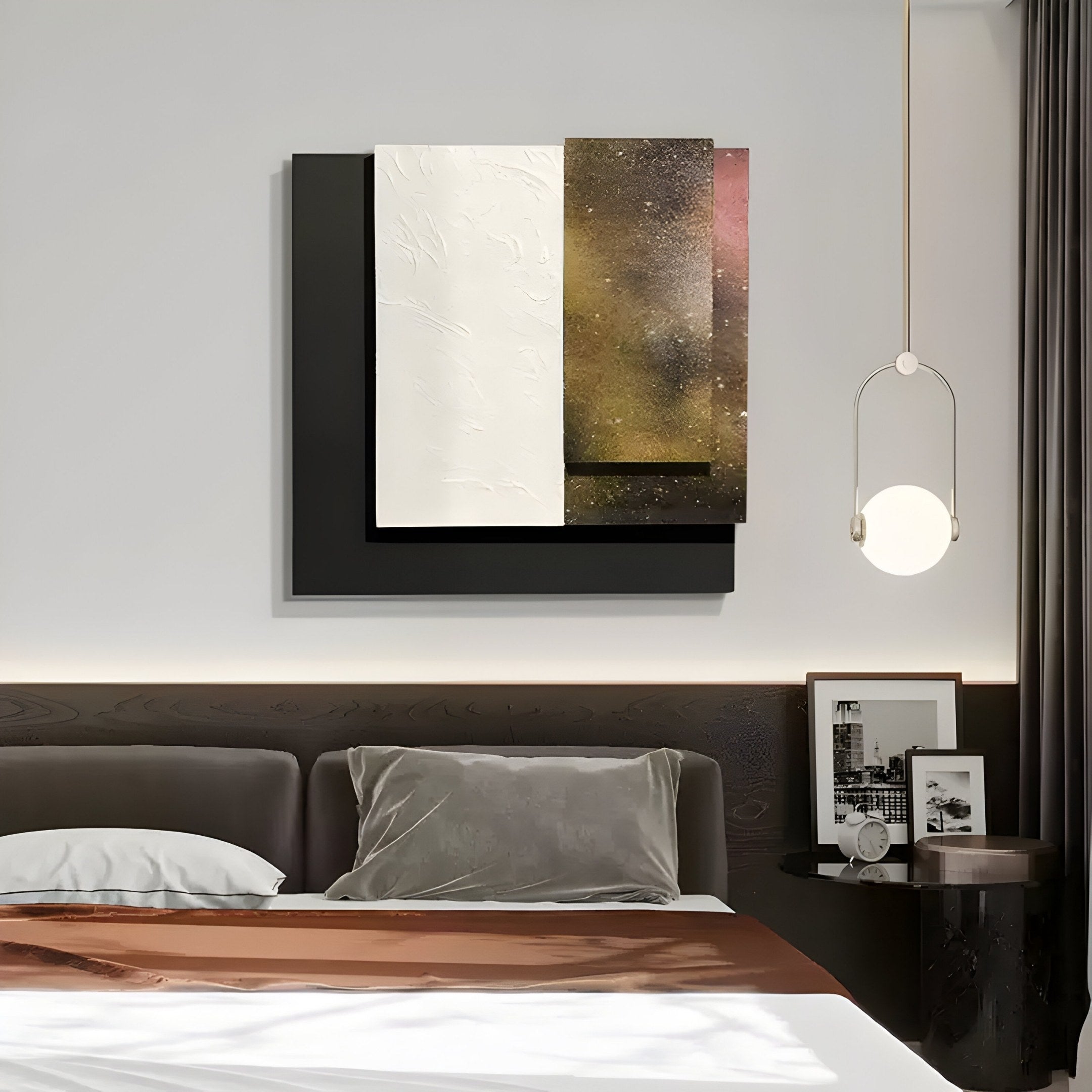 In a modern bedroom, a bed with gray, white, and brown bedding sits beneath abstract black and white 3D wall art. A celestial-themed pendant light hangs near the nightstand with framed photos and an Astra Stardust Gold Textured Wood Carving by Giant Sculptures.