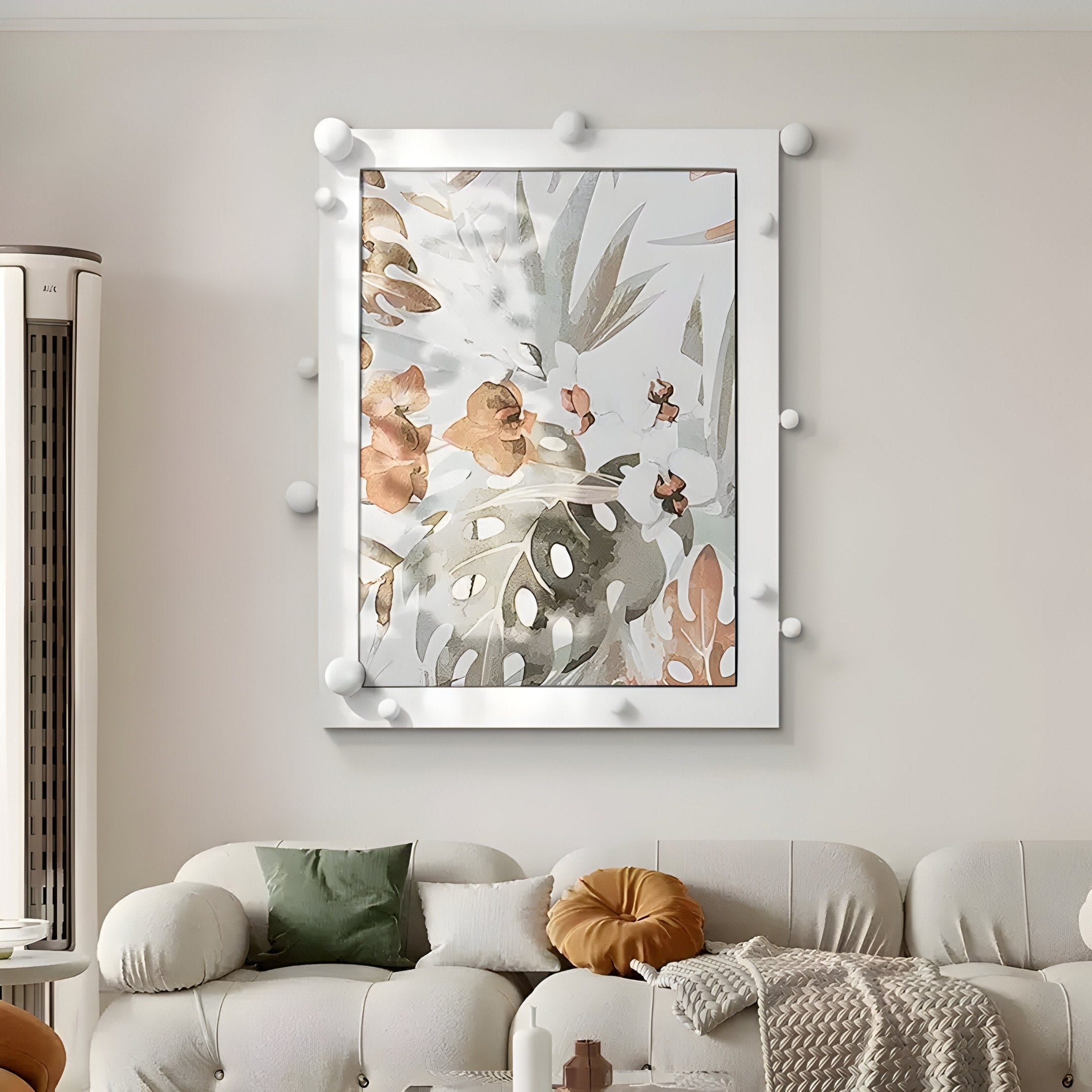 A modern living room features a white sofa with green and mustard pillows. Hanging on the cream wall is the Florere Botanical Harmony, a large hand-painted artwork by Giant Sculptures. The pieces spherical white accents add texture to the decor.