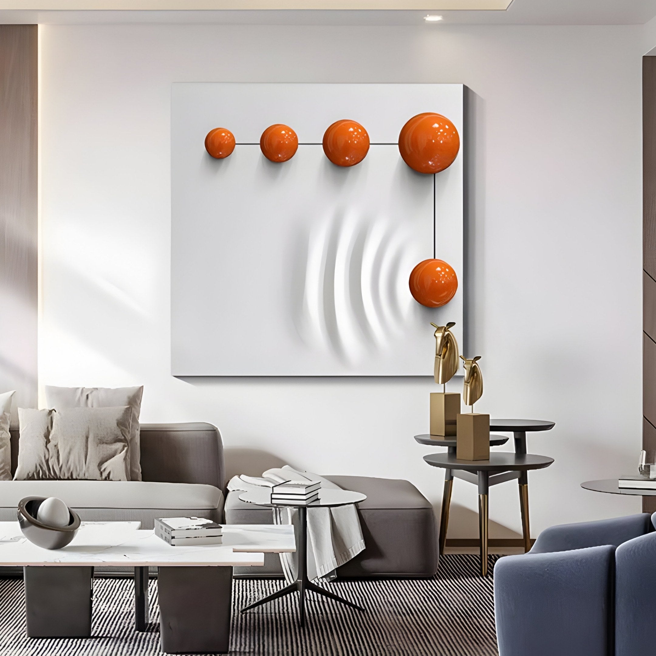 The modern living room features Giant Sculptures Galactica White Wood Relief 3D Wall Art with Linear Orange Metal Ball, a gray sofa, a contemporary coffee table, a side table with gold sculptures, and subtle lighting, creating a sleek and artistic atmosphere.