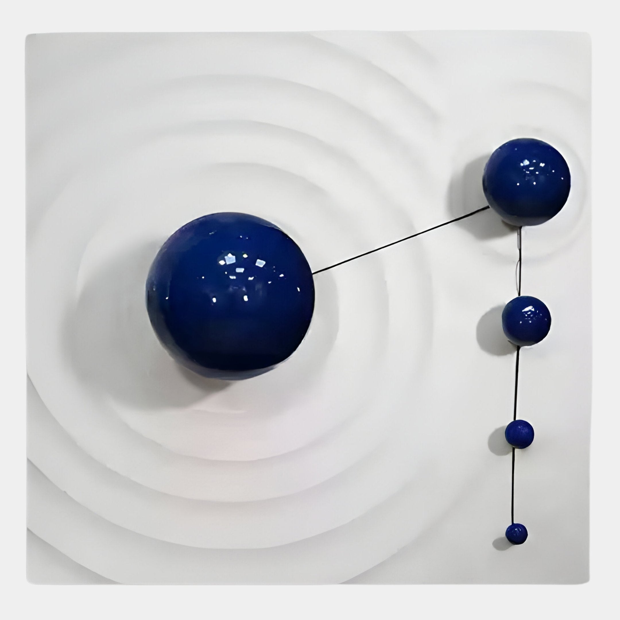 The Galactica White Wood Relief 3D Wall Art With Blue Metal Ball by Giant Sculptures features five glossy blue metal balls linked by slim black lines on a grooved white surface, creating a striking minimalist relief effect.