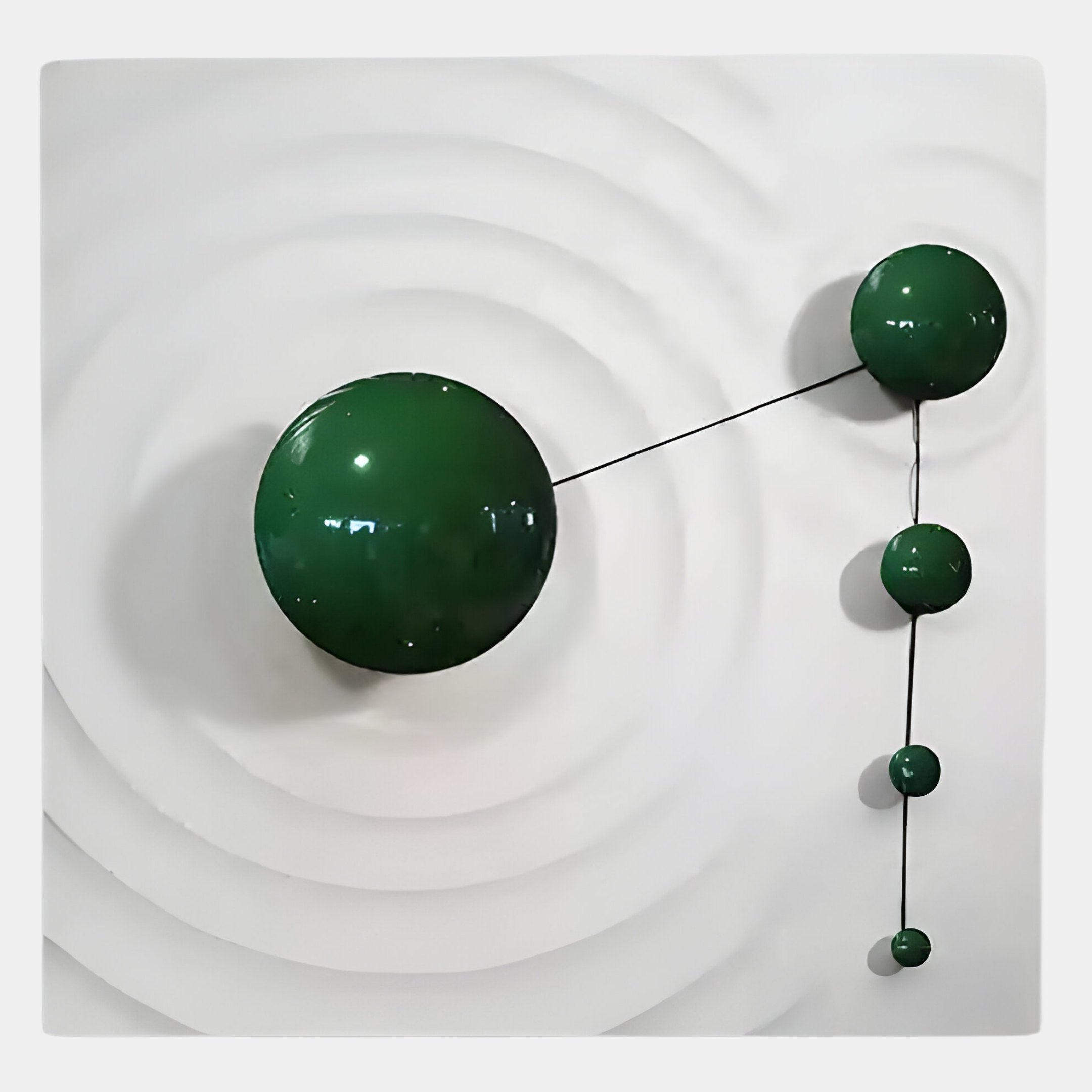 The Galactica White Wood Relief 3D Wall Art With Green Metal Ball by Giant Sculptures features five glossy green metal spheres connected by black rods, set on a geometric white wood background with circular grooves.
