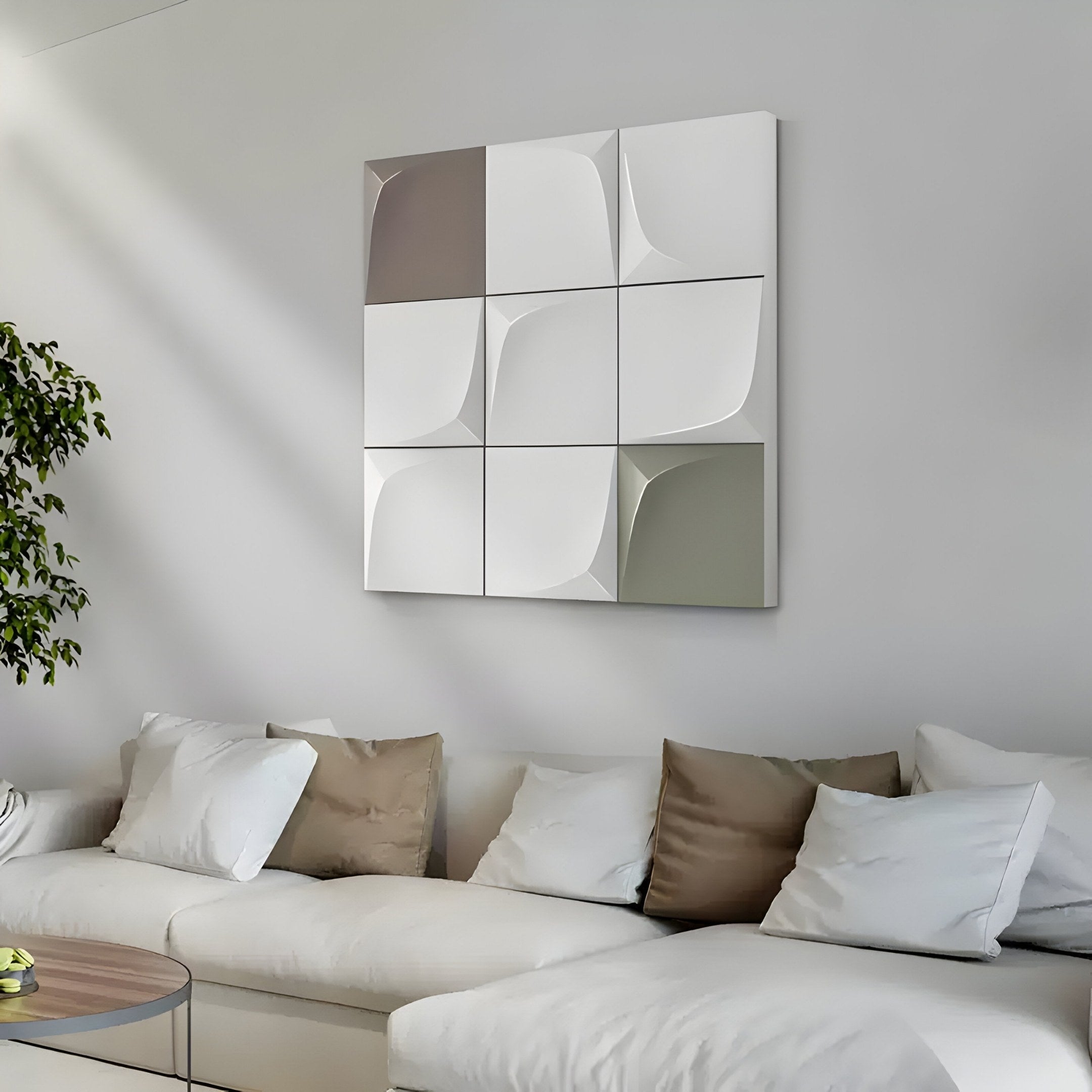 A modern living room showcases a Curvatura White sectional sofa with beige and white pillows. Above the sofa, a Giant Sculptures 3D Wood Relief Wall Art featuring neutral tones adorns the light gray wall, while greenery flourishes from a potted plant in this chic space.