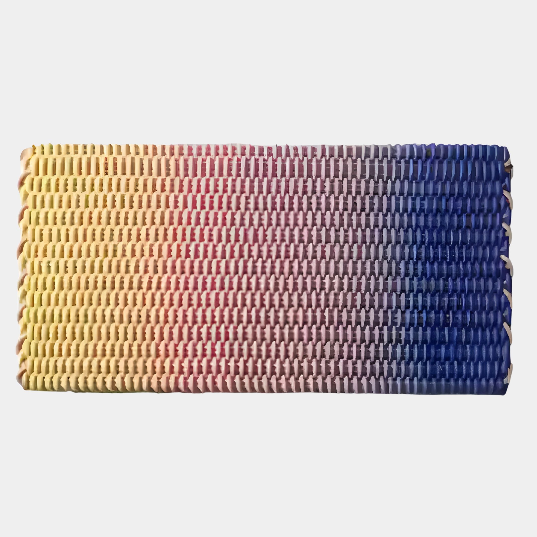 The Spectrum Weave Horizontal Sunset Hues Wood Relief 3D Wall Art by Giant Sculptures is a rectangular mat with horizontal weaving, featuring a gradient from yellow to pink, red, and blue against a plain white background.