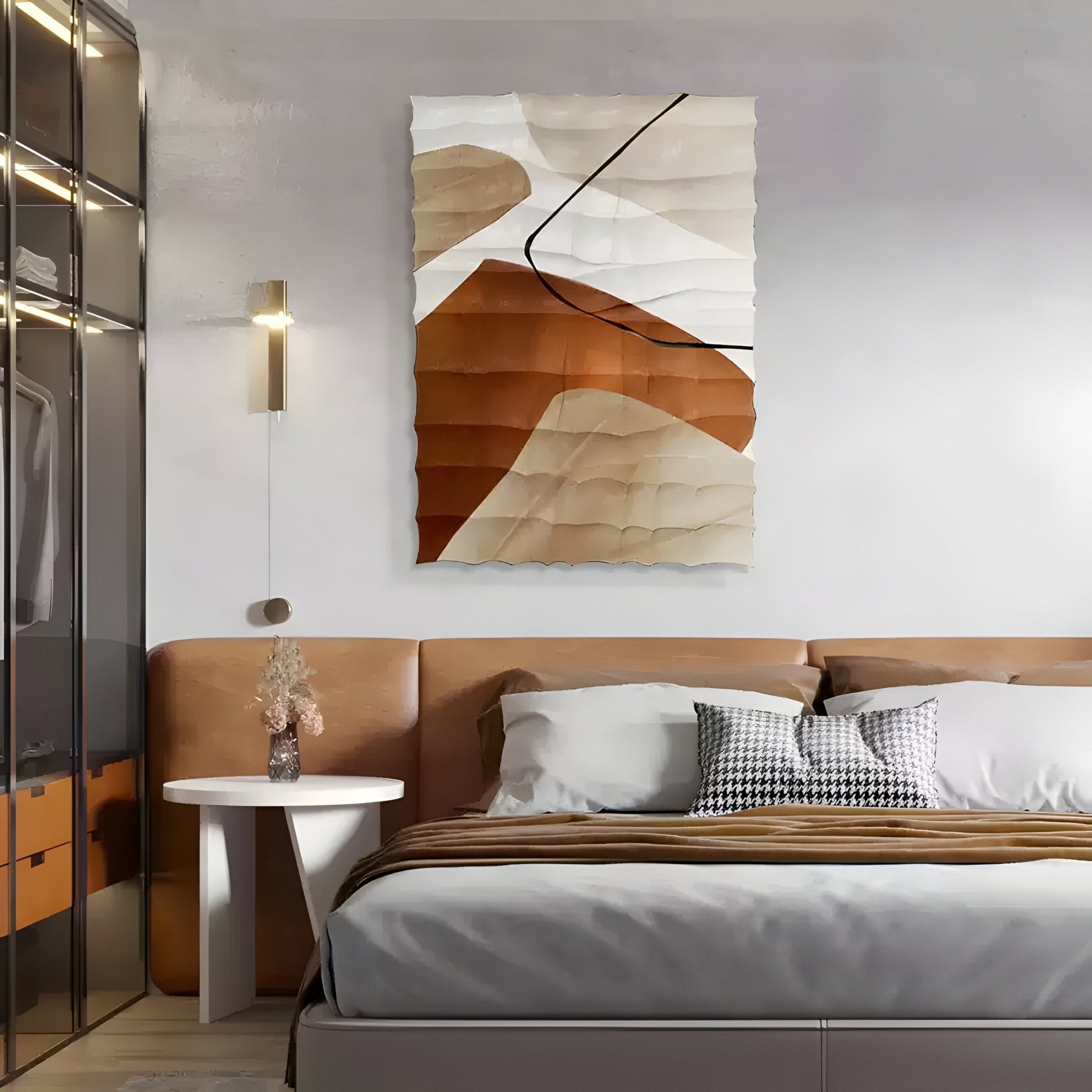 A modern bedroom showcases the Terracurve I Hand-Painted Sandstone Wood Relief 3D Wall Art by Giant Sculptures above a bed with a leather headboard. An earthy elegance is added by a round white side table with a vase, complemented by sleek closet doors and neutral tones bathed in soft lighting for coziness.