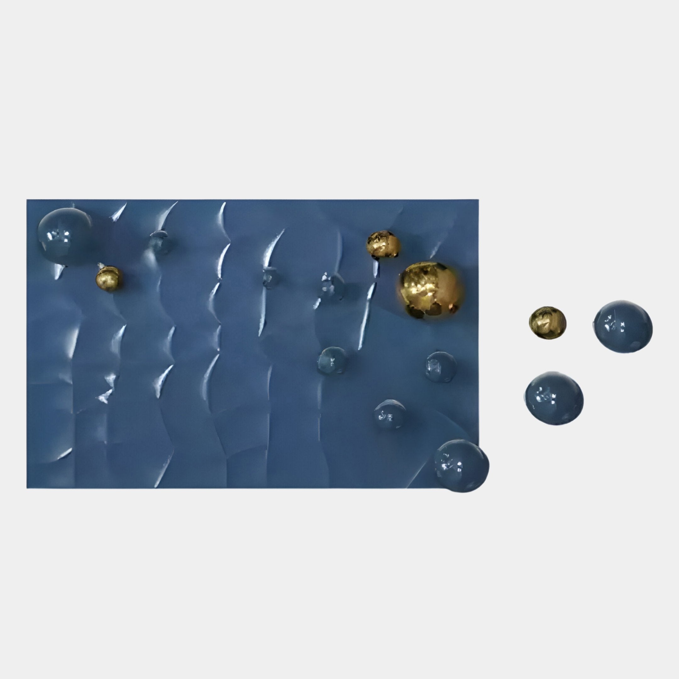 The Orbison Blue 3D Wood Relief Wall Art With Floating Metal Ball by Giant Sculptures features a rectangular blue wavy surface with shiny blue and gold spheres, some inside and some floating outside, creating a dynamic effect.