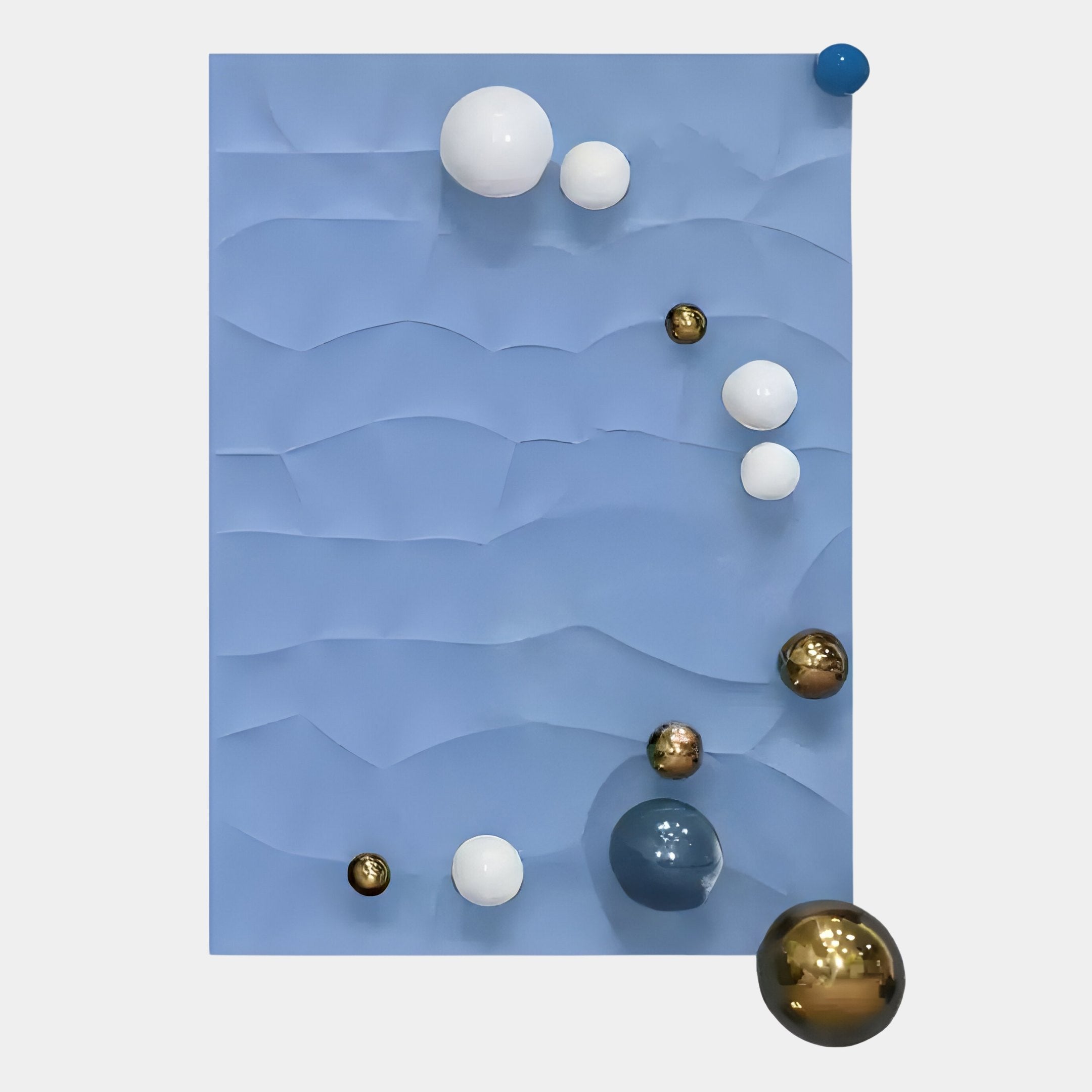 The Orbison Sky Blue 3D Wood Relief Wall Art With Metal Ball by Giant Sculptures features a blue rectangular background with layered wavy textures and scattered white, gold, blue, and dark blue spheres for a unique 3D effect.